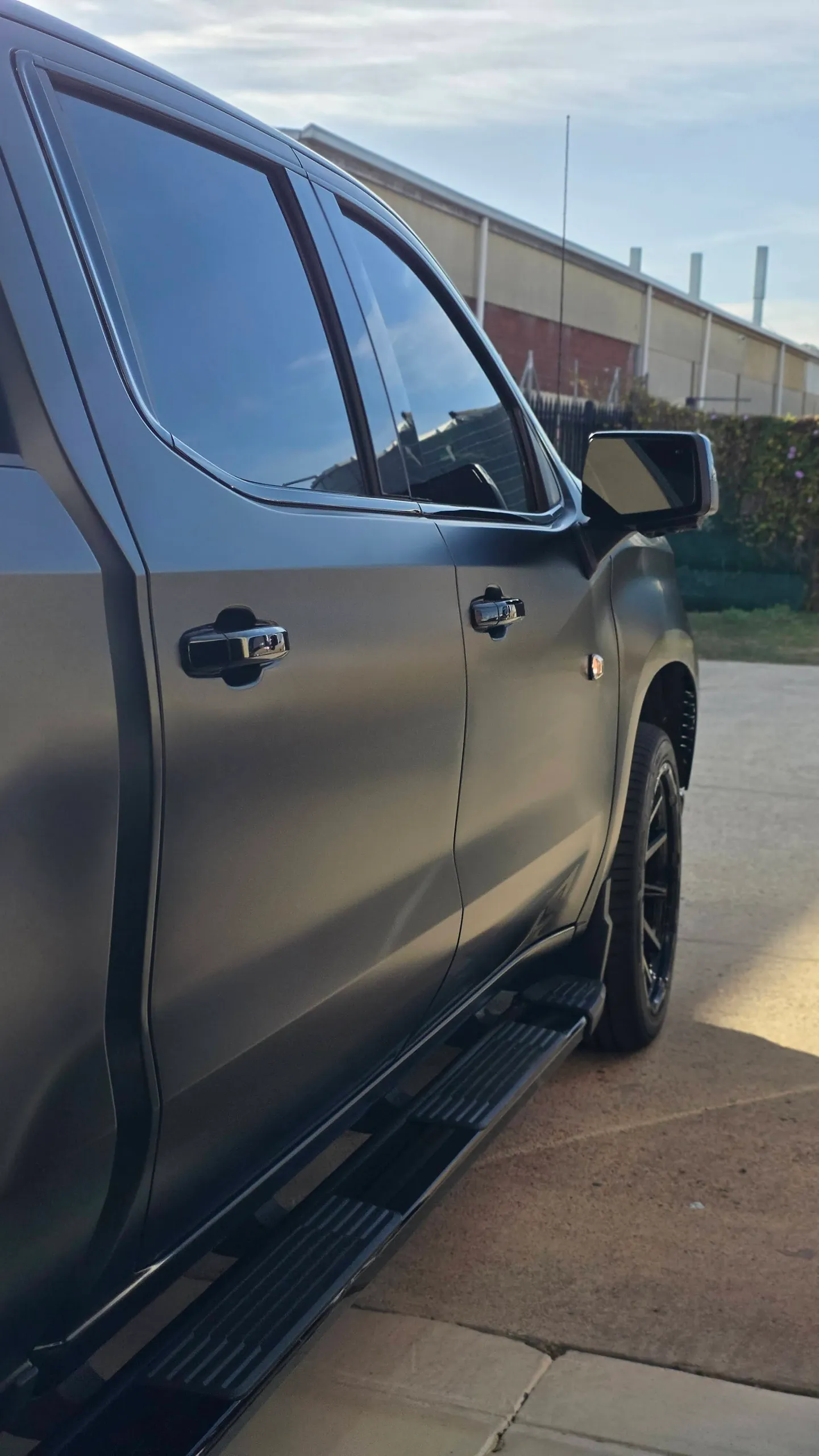 Satin black Chevrolet Silverado doors, mirror and running board outdoors