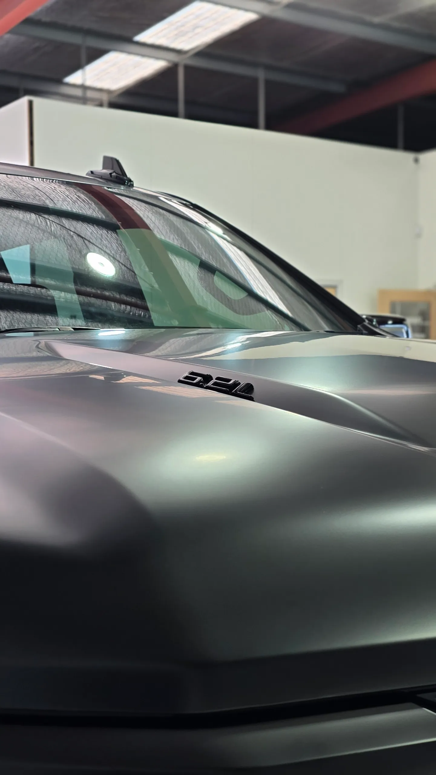 Soft highlights across the satin black Chevrolet Silverado bonnet