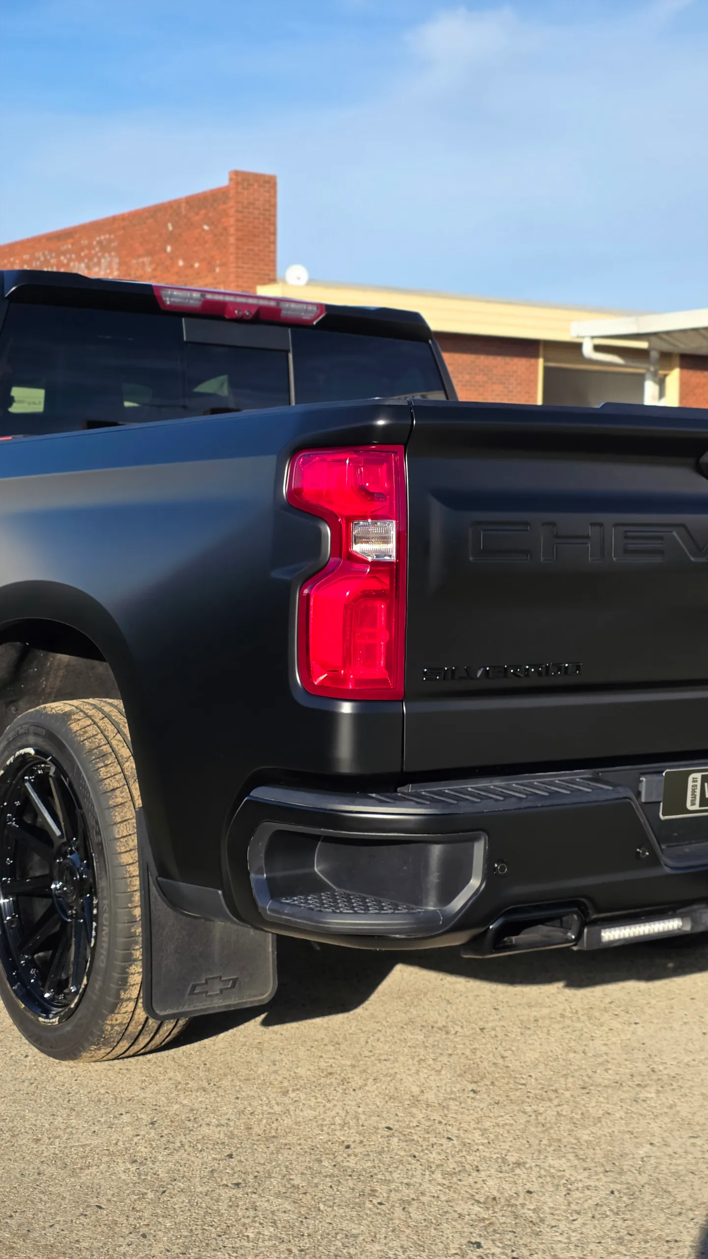 Chevrolet Silverado rear light, tailgate and rear wheel in a satin black finish