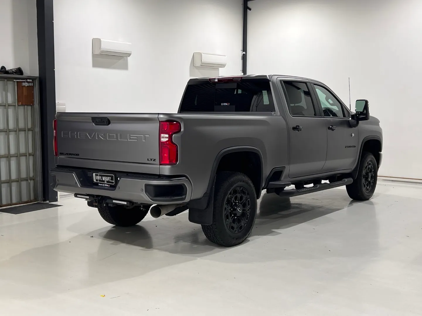Matte anthracite Chevrolet Silverado rear quarter and tailgate in the workshop