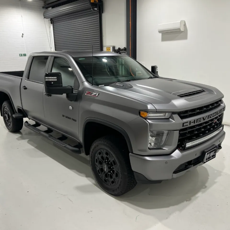 Matte anthracite Chevrolet Silverado front quarter and side in the workshop