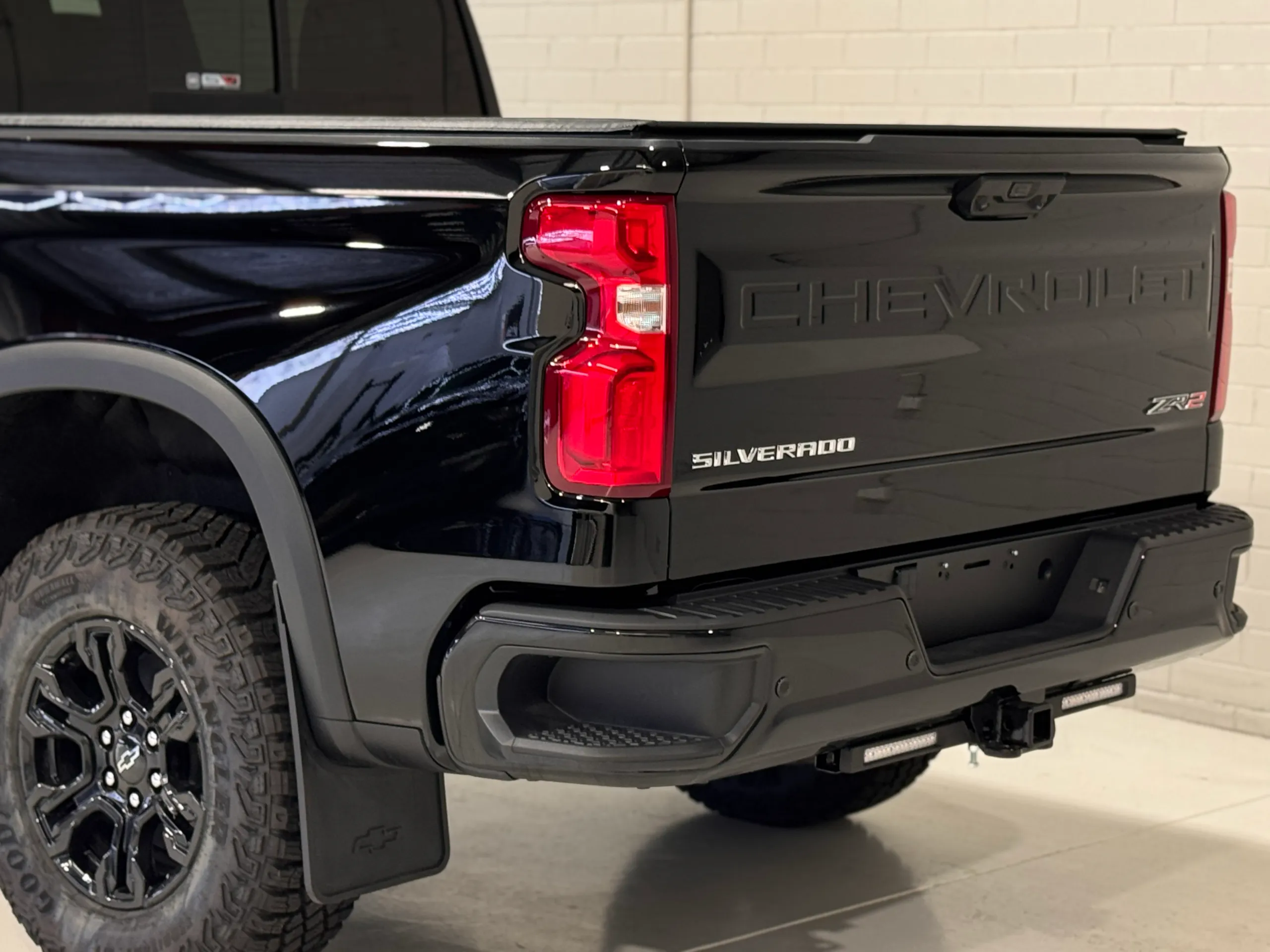 Gloss black Silverado ZR2 tailgate, rear light and rear wheel in the workshop