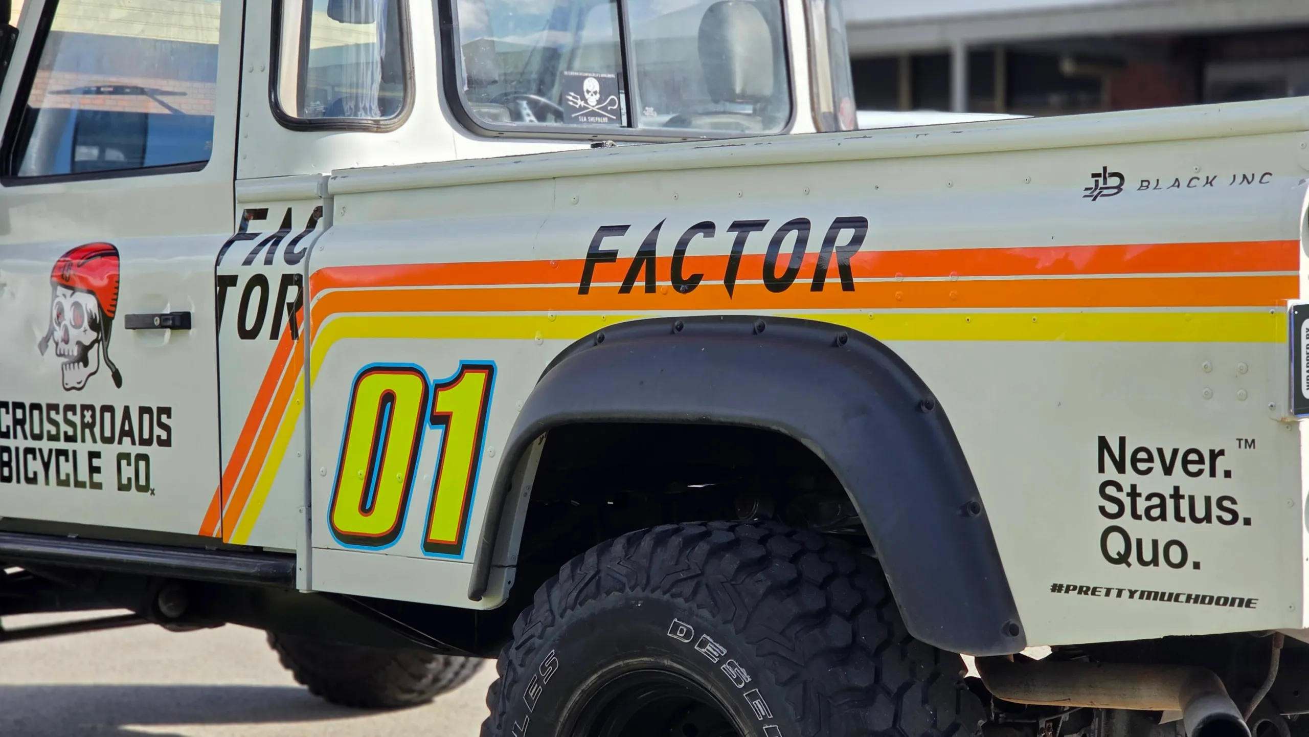 Cream Defender rear side panel with Factor lettering, number 01 and coloured stripes
