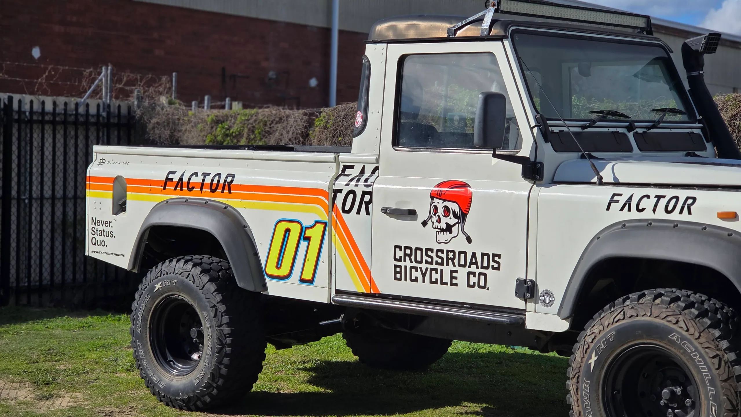 Land Rover Defender cab and tub with Crossroads Bicycle Co graphics outdoors