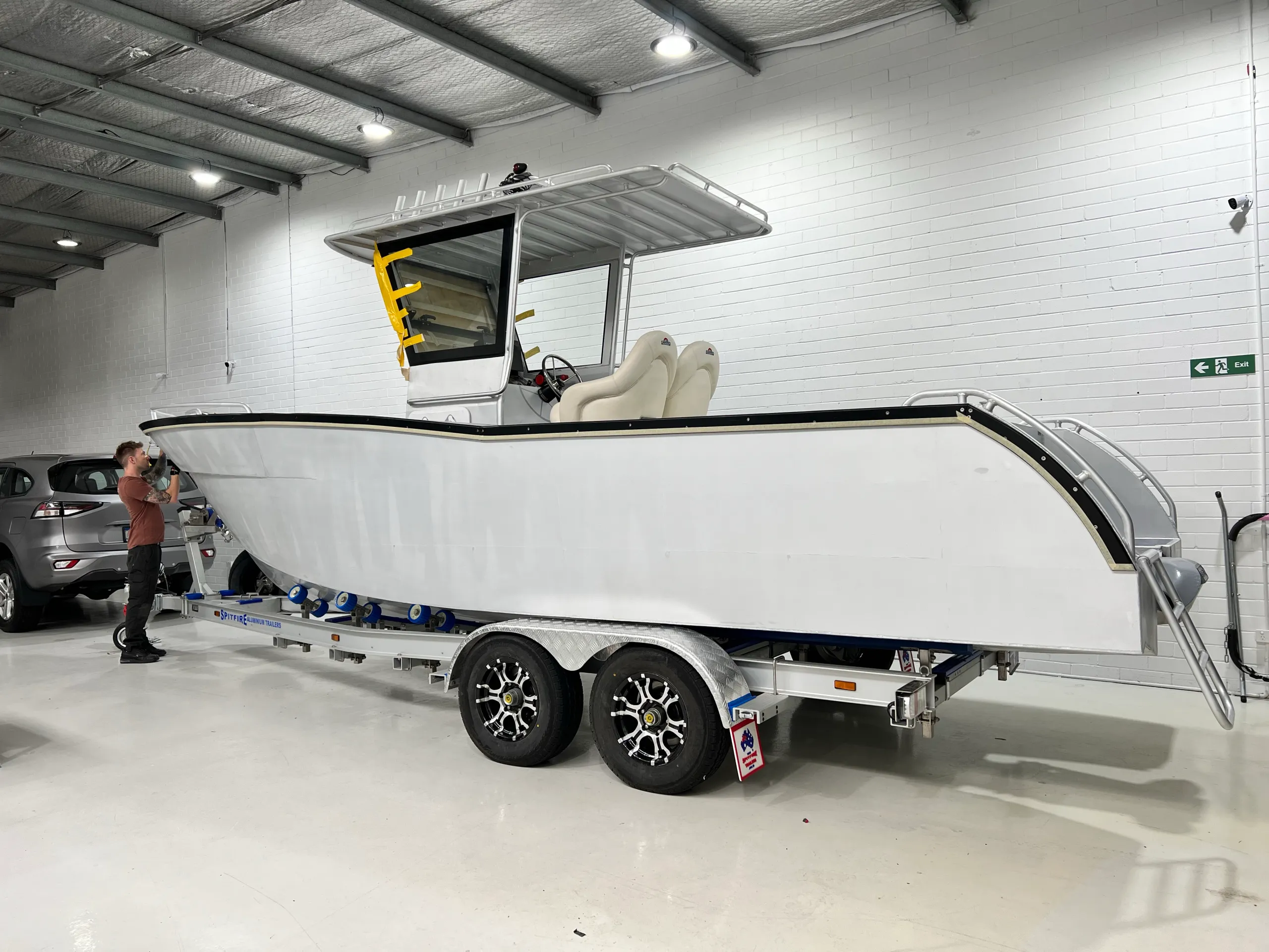 White boat being prepared for wrapping with masking tape around the cabin windscreen