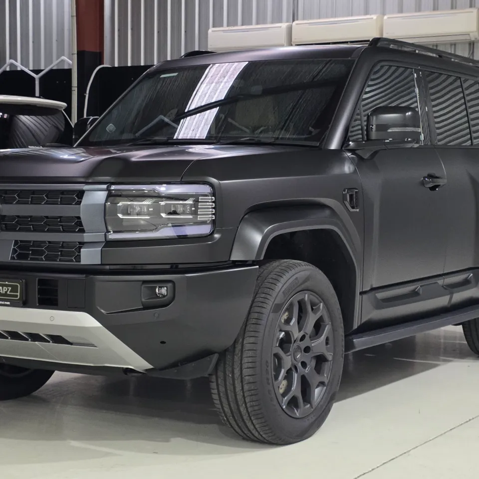 Satin dark grey Denza B5 viewed from the front quarter in the workshop