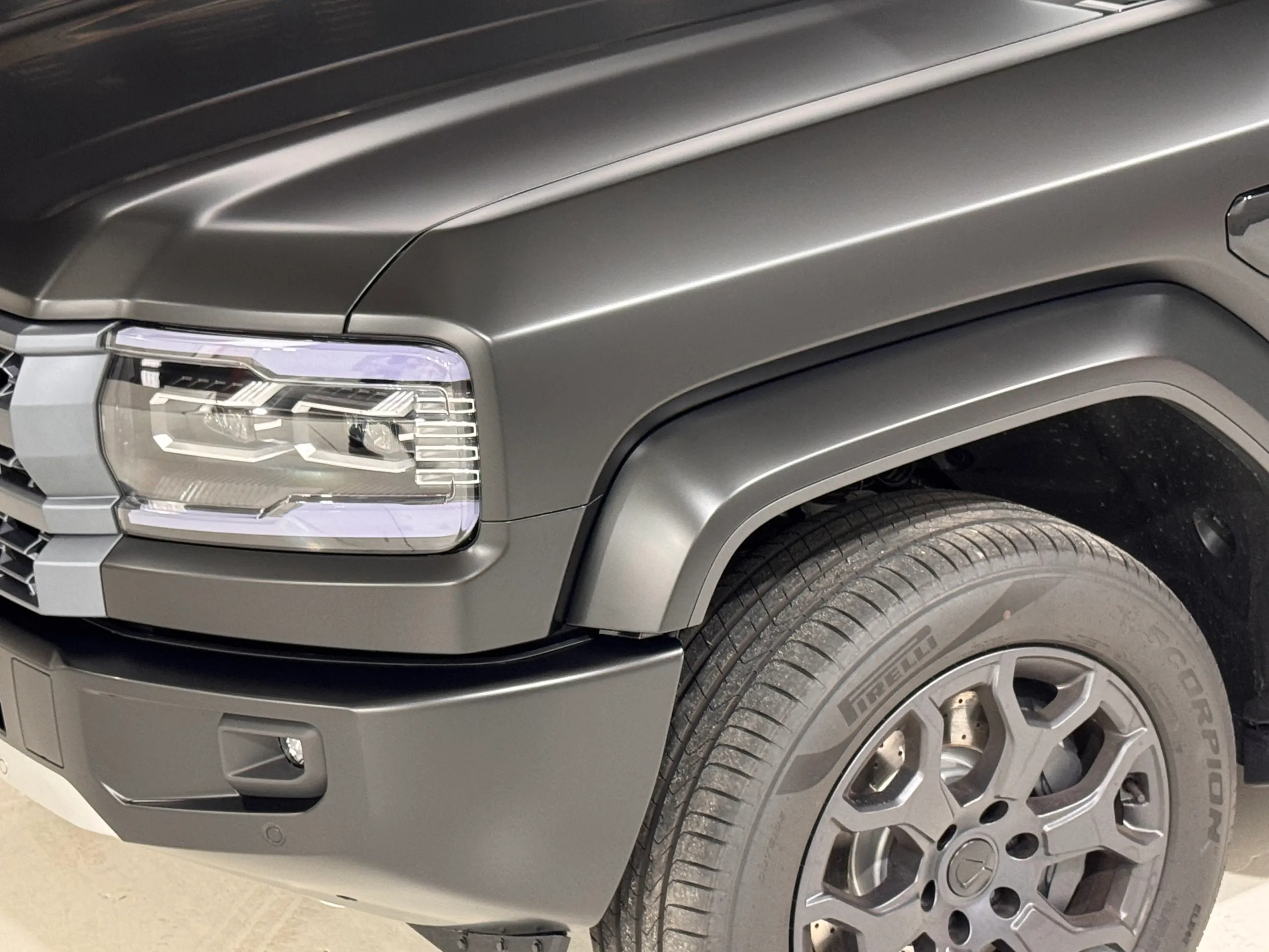 Denza B5 headlight, satin grey front guard and wheel inside the workshop