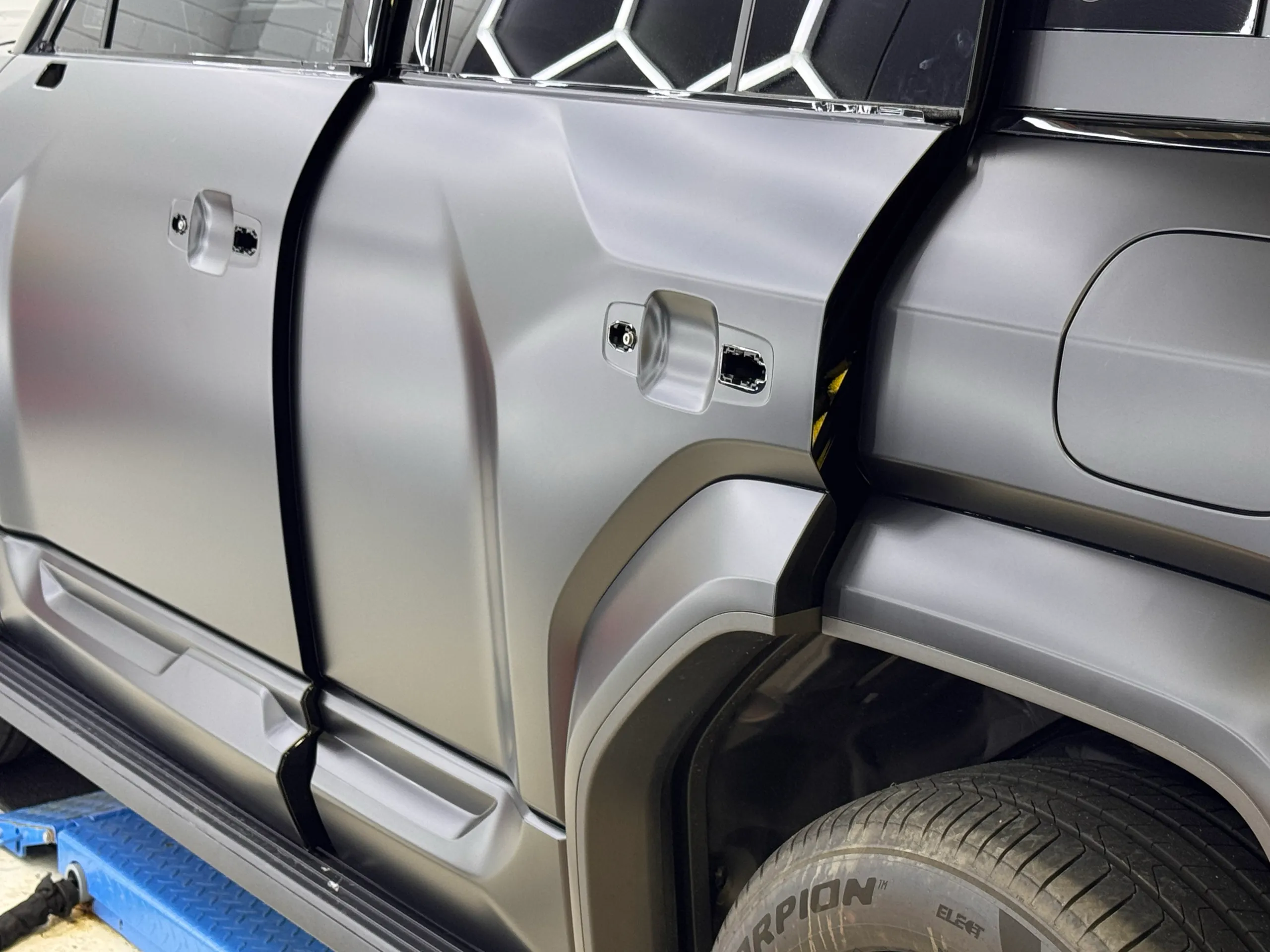Satin grey Denza B5 doors during installation with their handles removed