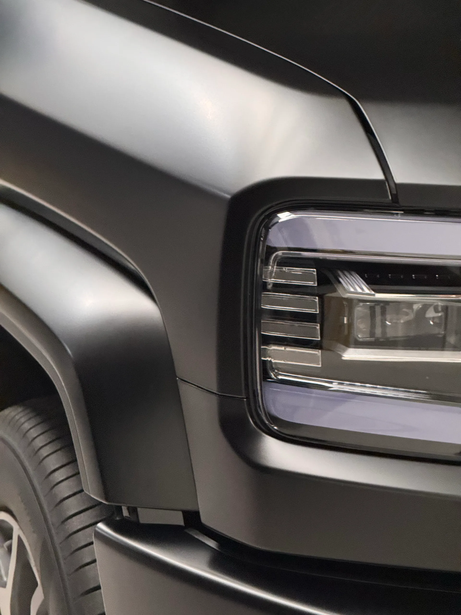 Close view of the Denza B5 headlight and satin grey front guard
