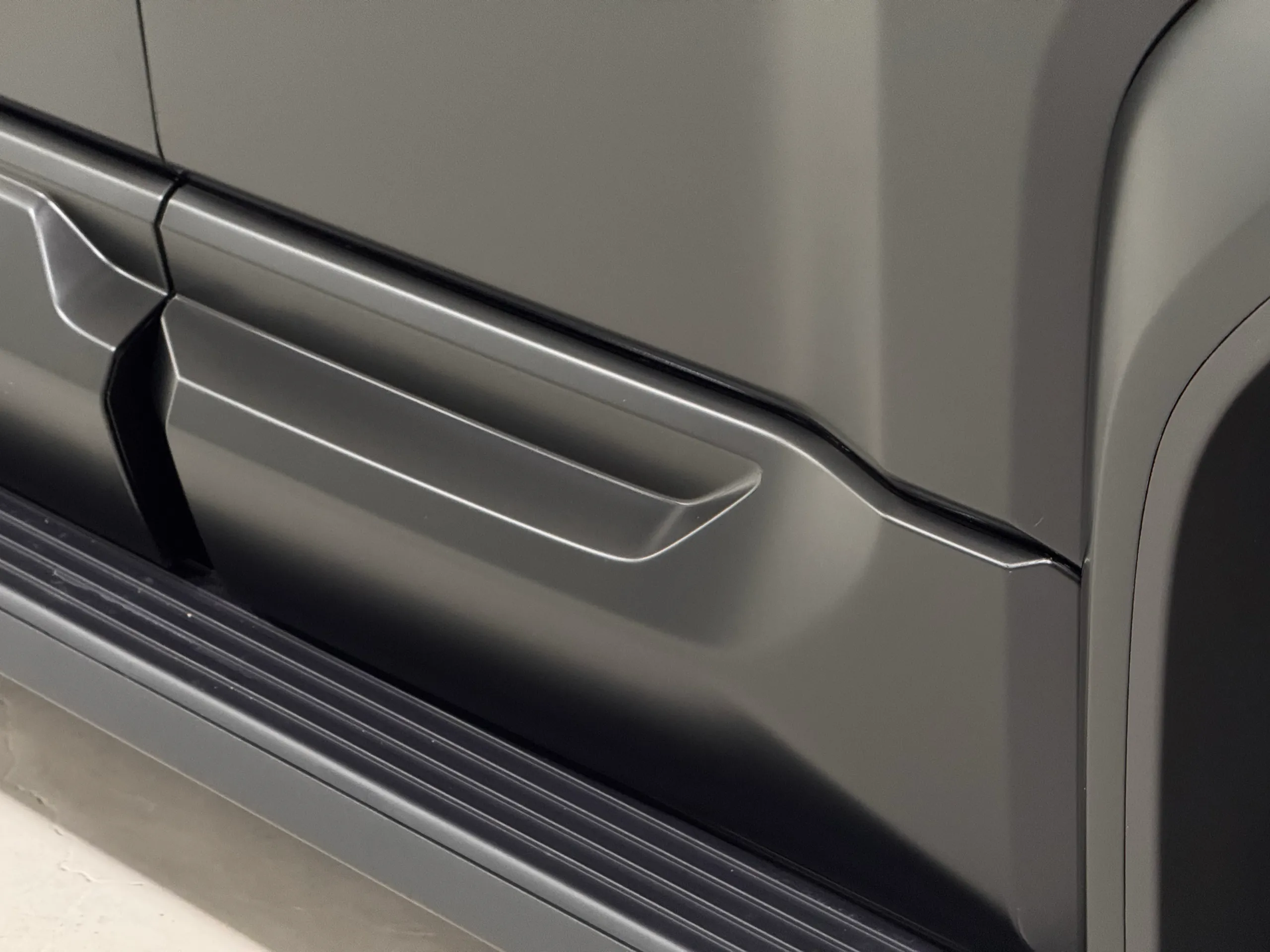 Satin grey lower door mouldings above the Denza B5 side step