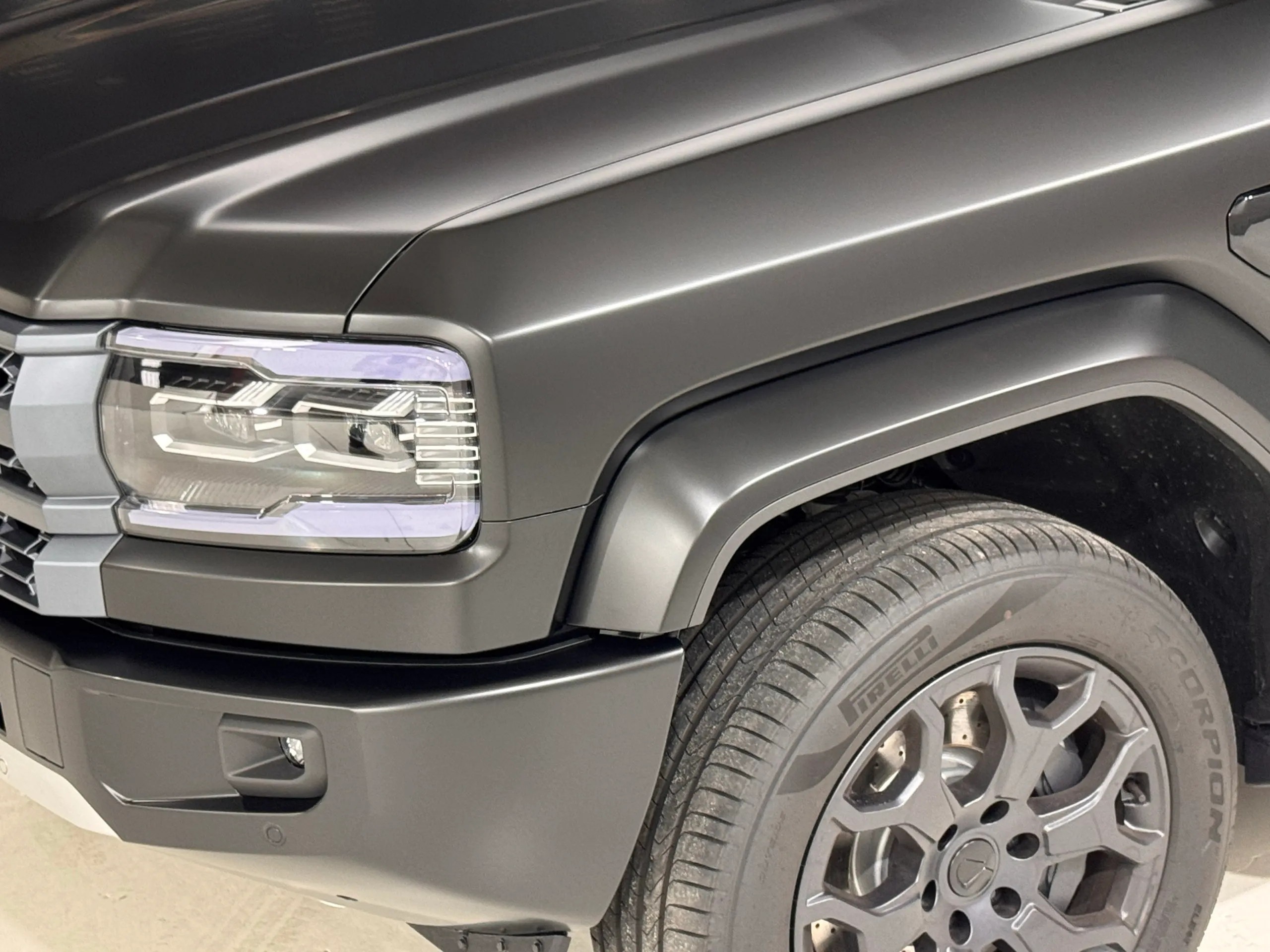 Denza B5 headlight, front bumper and wheel beneath satin grey bodywork