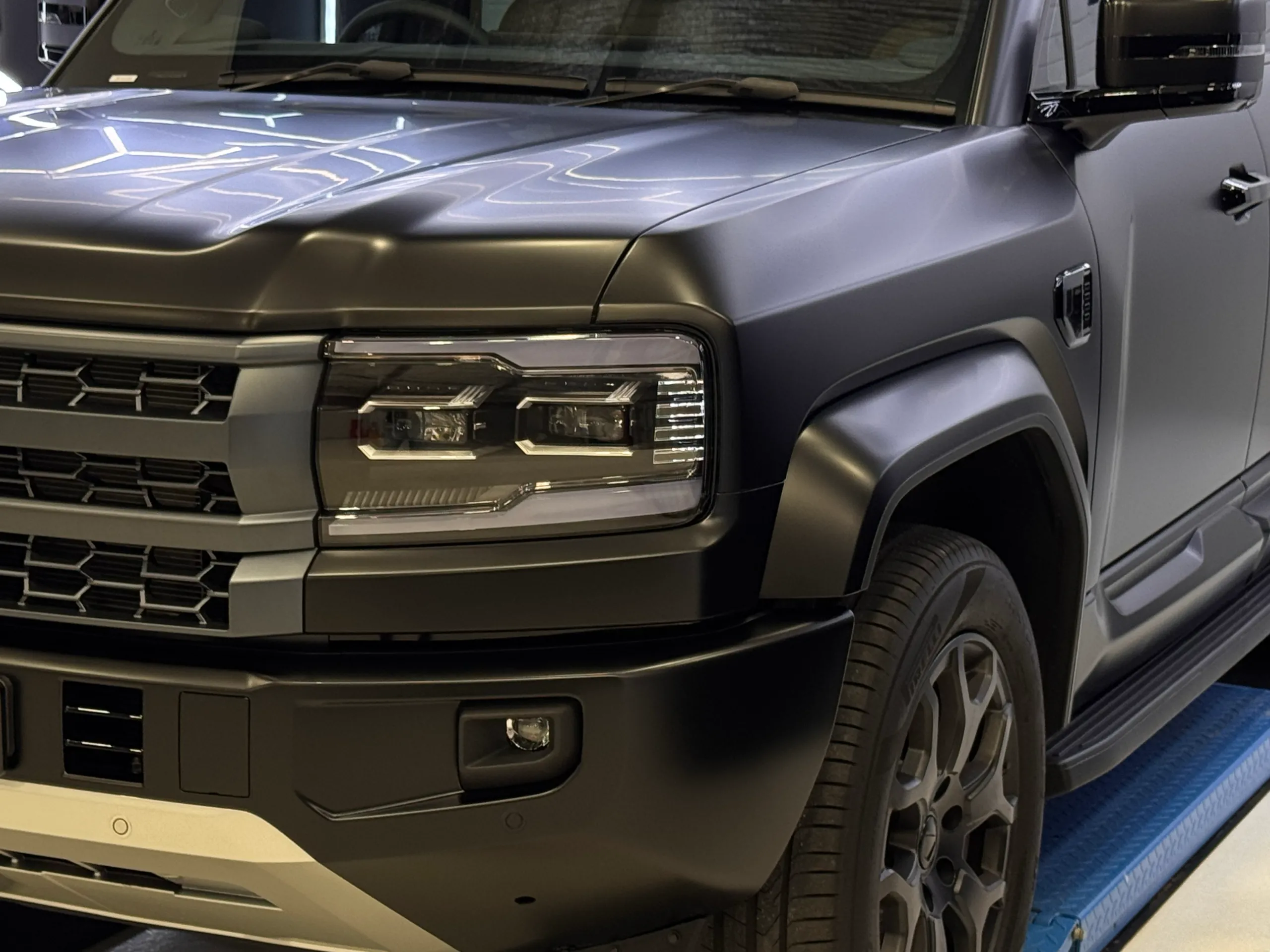 Denza B5 bonnet, headlight and front guard under workshop lighting