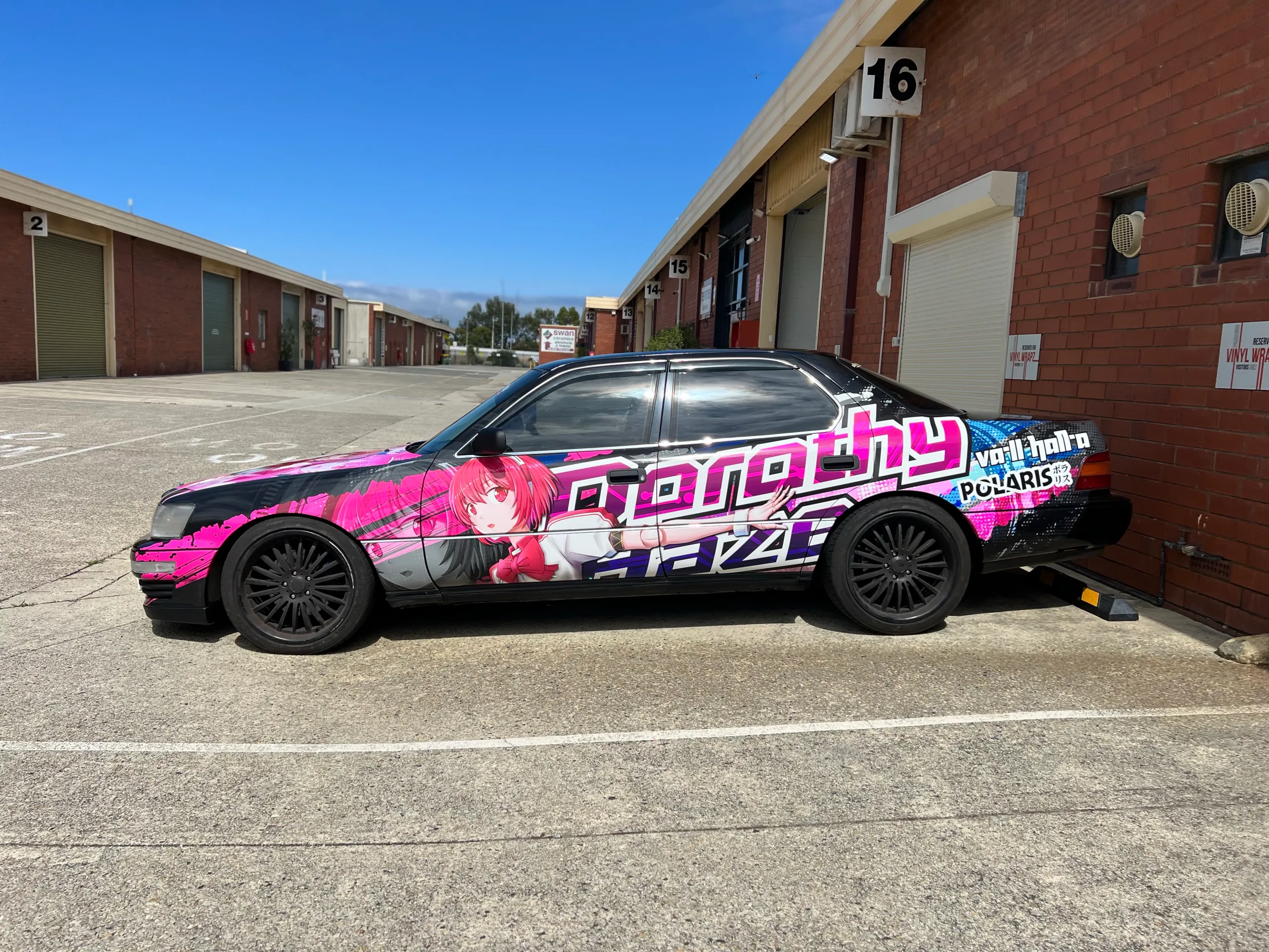 Completed black and pink anime wrap along the Toyota side