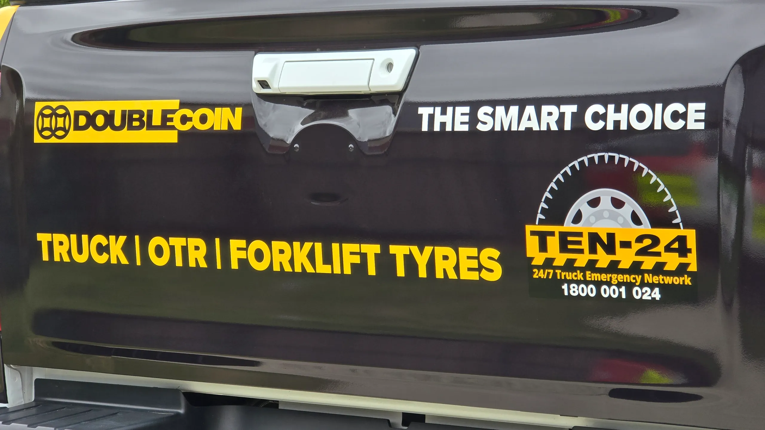 Double Coin and TEN-24 branding across the Mazda BT-50 black tailgate