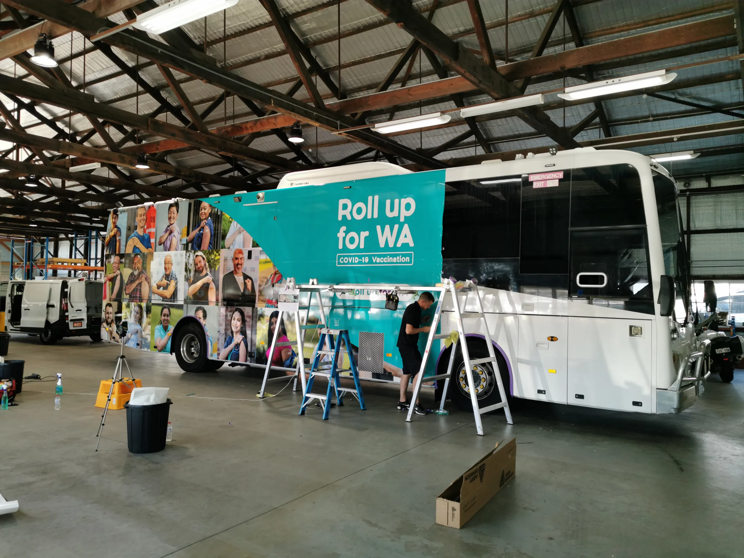 Installer working beside the coach front wheel