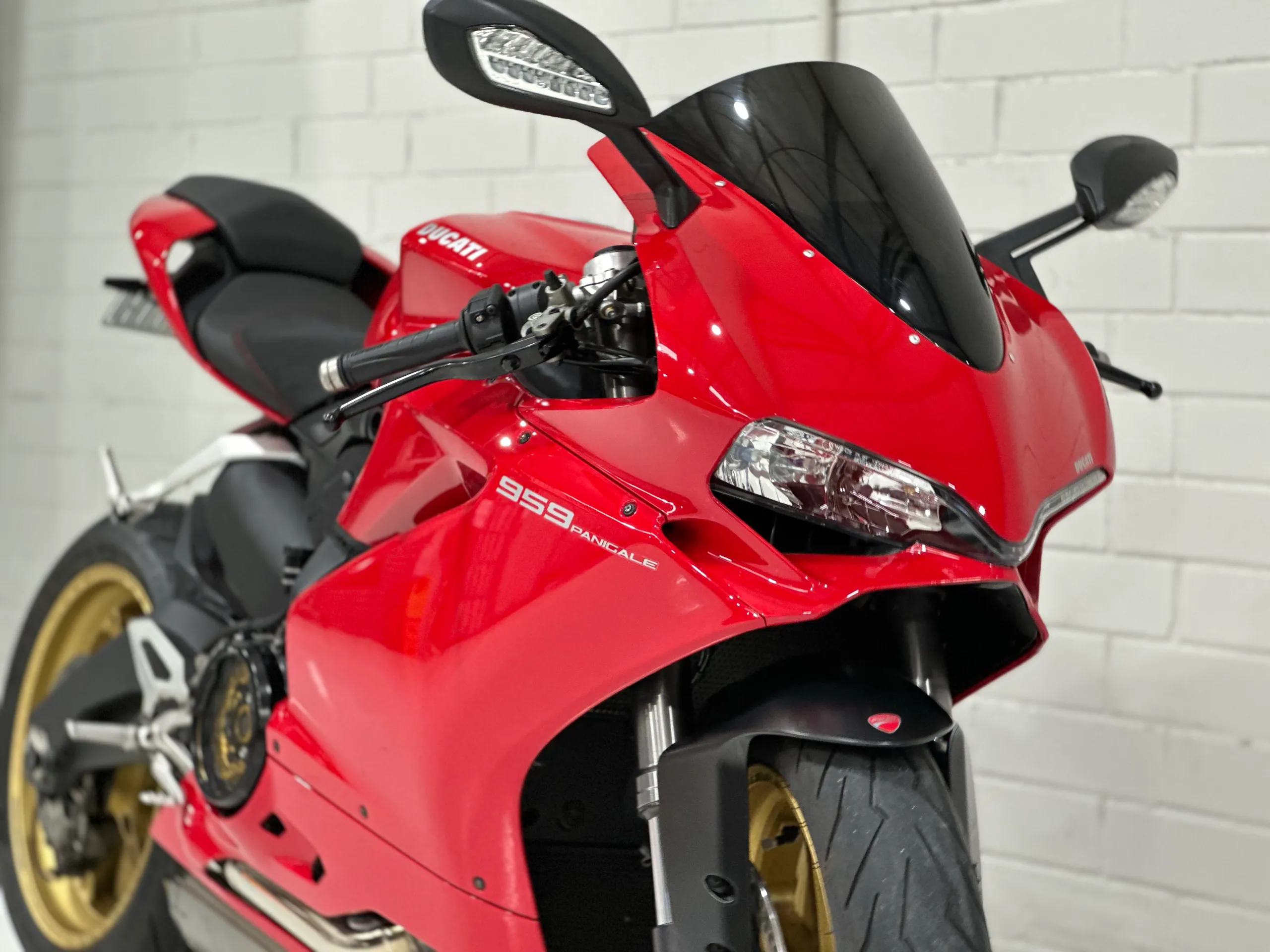Close-up of a red Ducati 959 Panigale front fairing, headlight and black windscreen