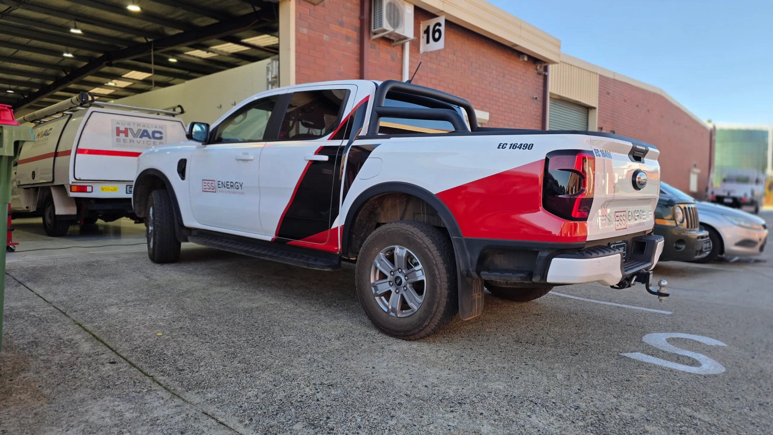 White Ford Ranger with ESS Energy and Site Services graphics across its doors and tray