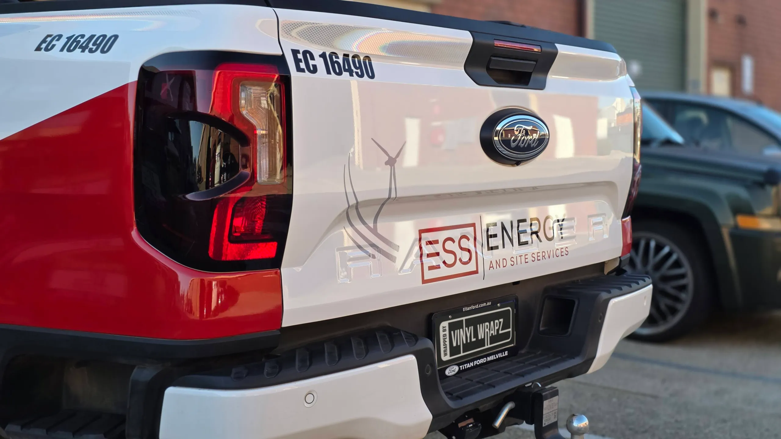 ESS Energy and Site Services tailgate graphics with wind-turbine artwork on a Ford Ranger