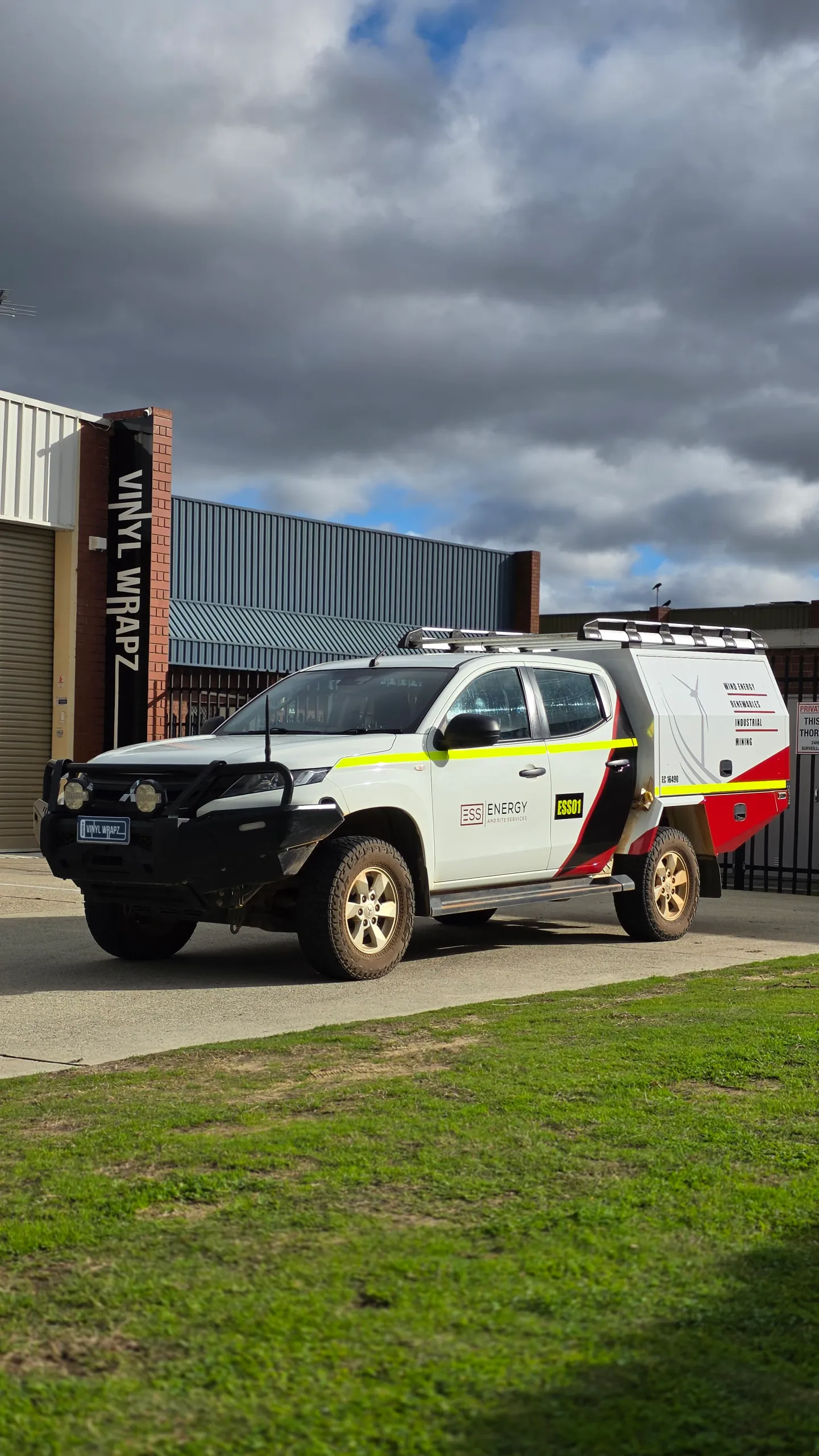 White Toyota Hilux with ESS Energy and Site Services canopy graphics and yellow accents