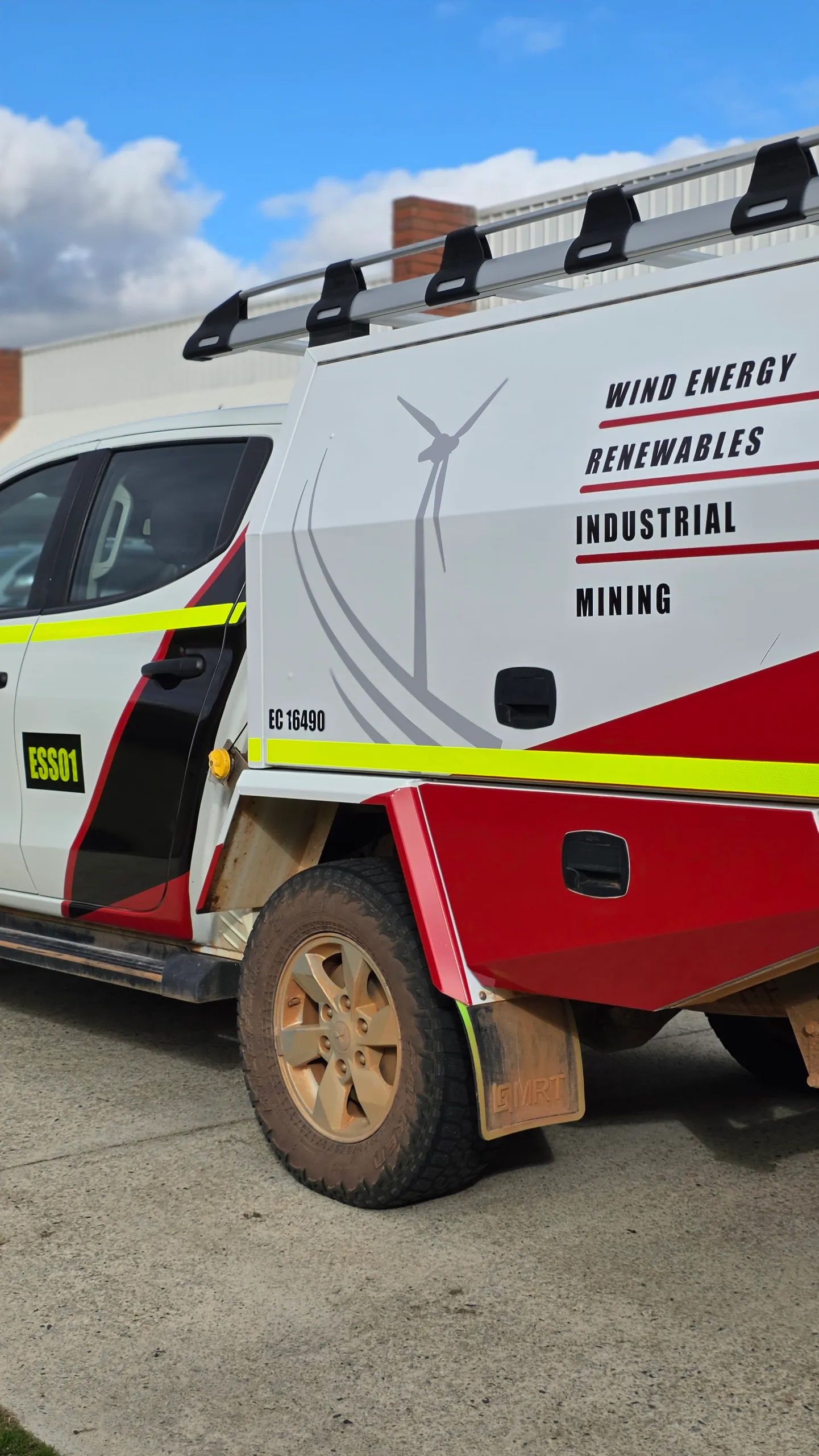 Wind-turbine artwork and ESS branding on the Hilux canopy side