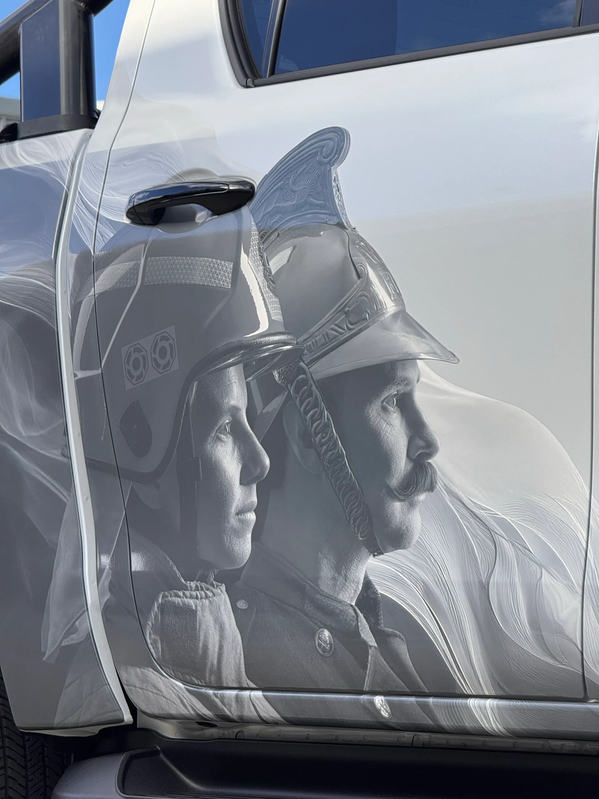 Printed firefighter portraits across the Toyota Hilux rear door