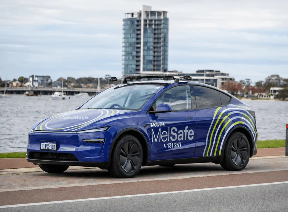 City of Melville MelSafe Tesla in its purple printed wrap with reflective livery, parked beside the Swan River