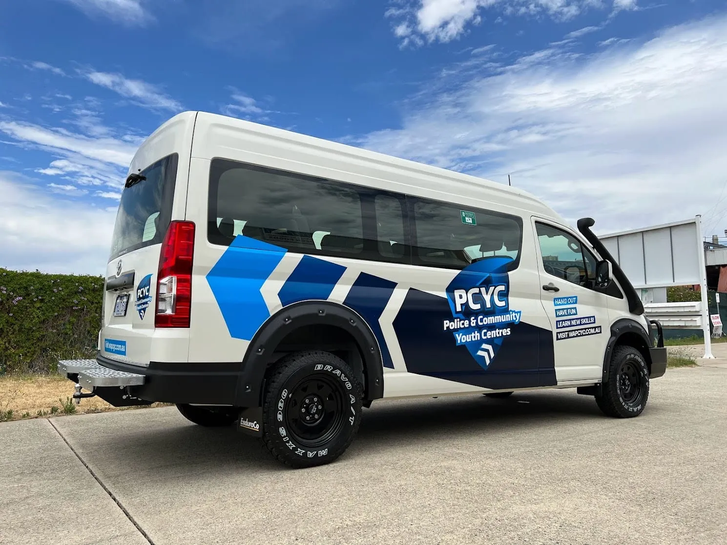 PCYC WA Toyota HiAce people mover in matching blue and white branding, Perth