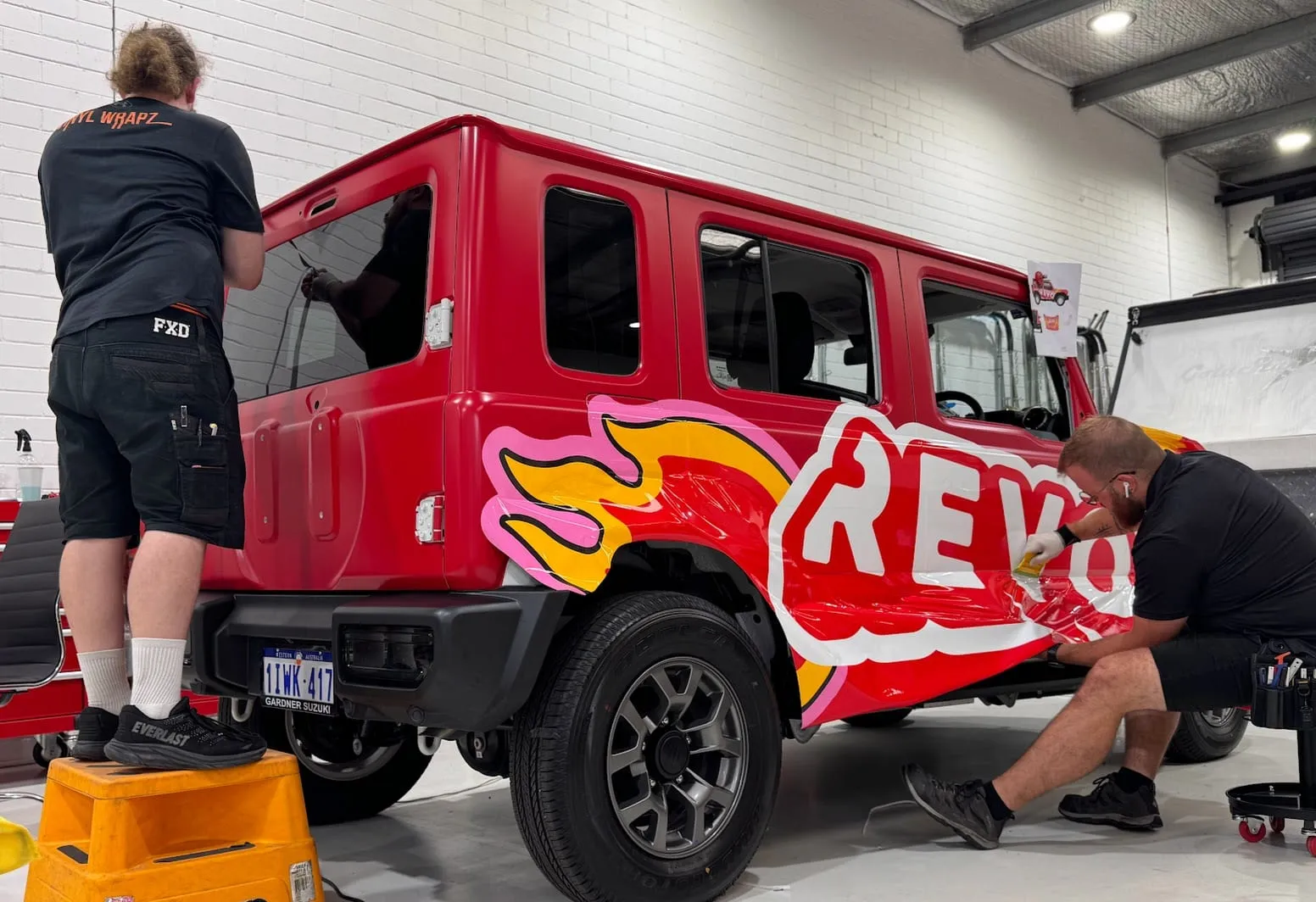 Suzuki Jimny in the printed Revo Fitness wrap, front three-quarter, by Vinyl Wrapz