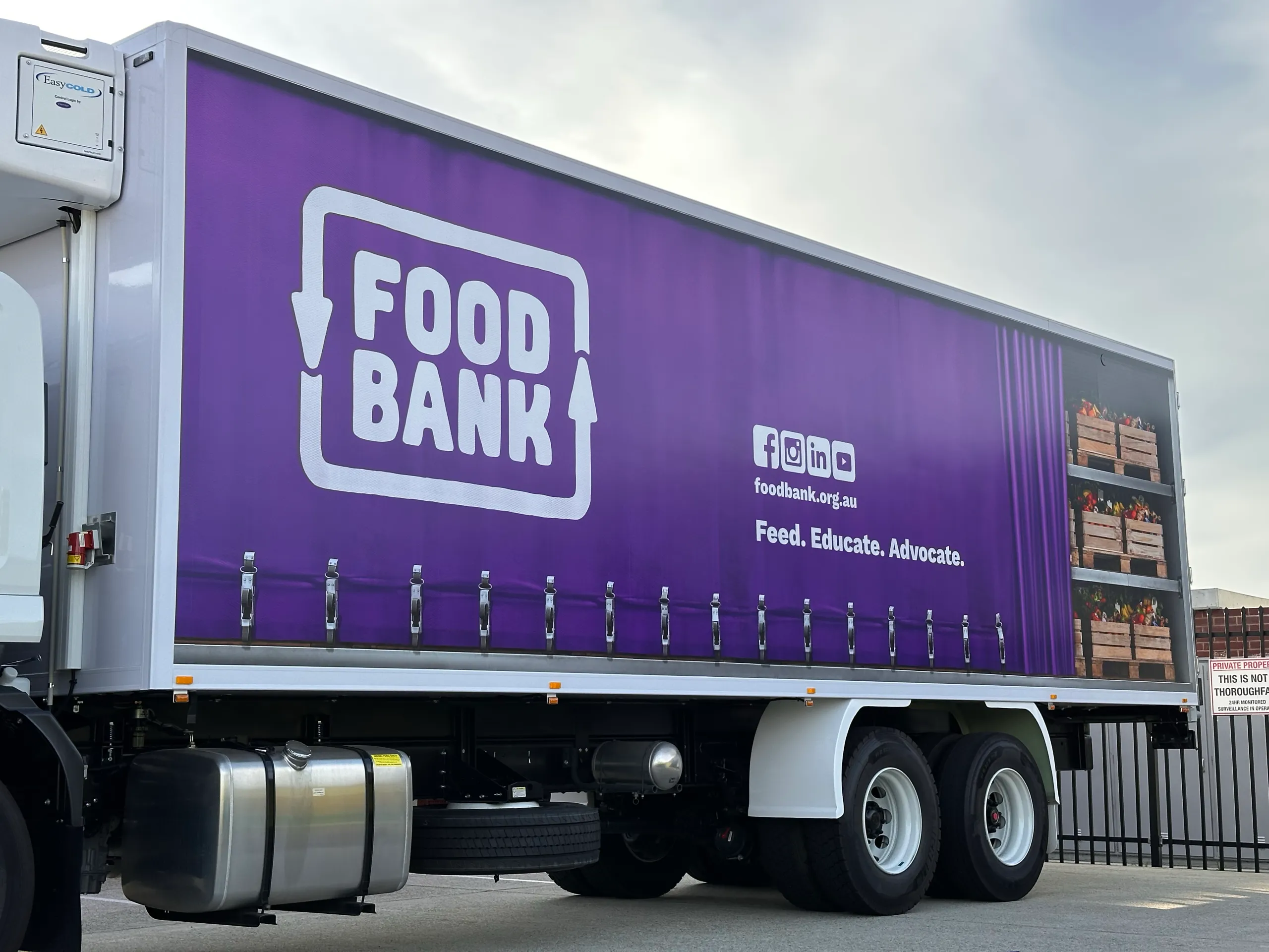 Large Foodbank logo and purple graphics across the refrigerated truck side
