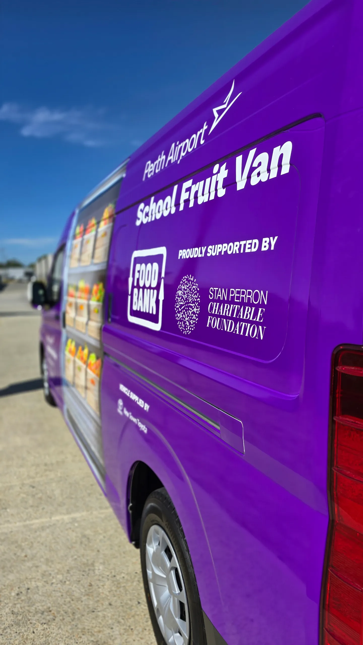 Perth Airport School Fruit Van and Foodbank branding on the purple Toyota Hiace rear side panel