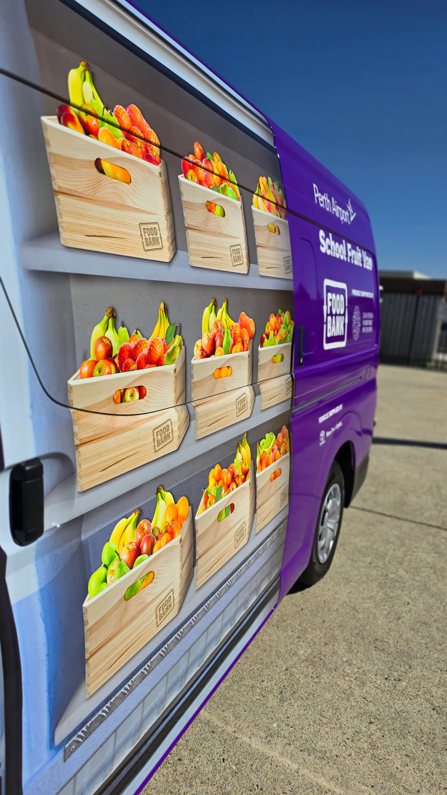 Printed fruit-crate artwork across the Foodbank Toyota Hiace sliding door