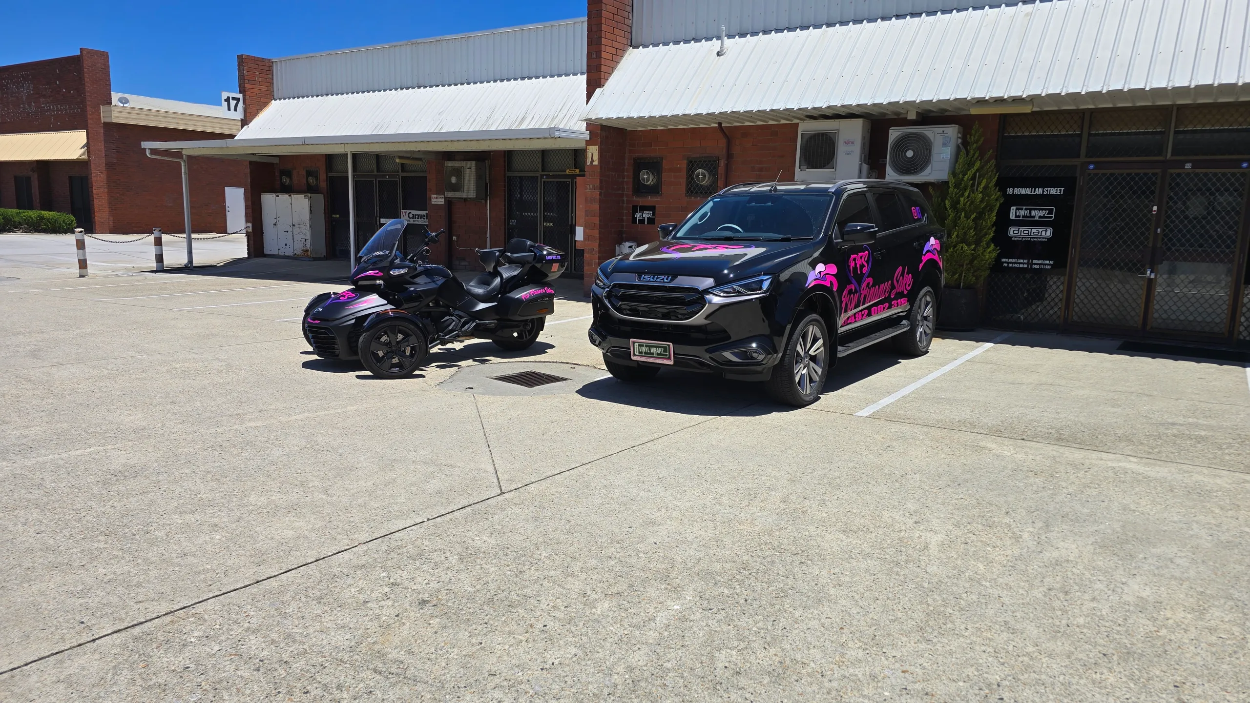 Wide view of the For Finance Sake MU-X and Can-Am Spyder outside the workshop