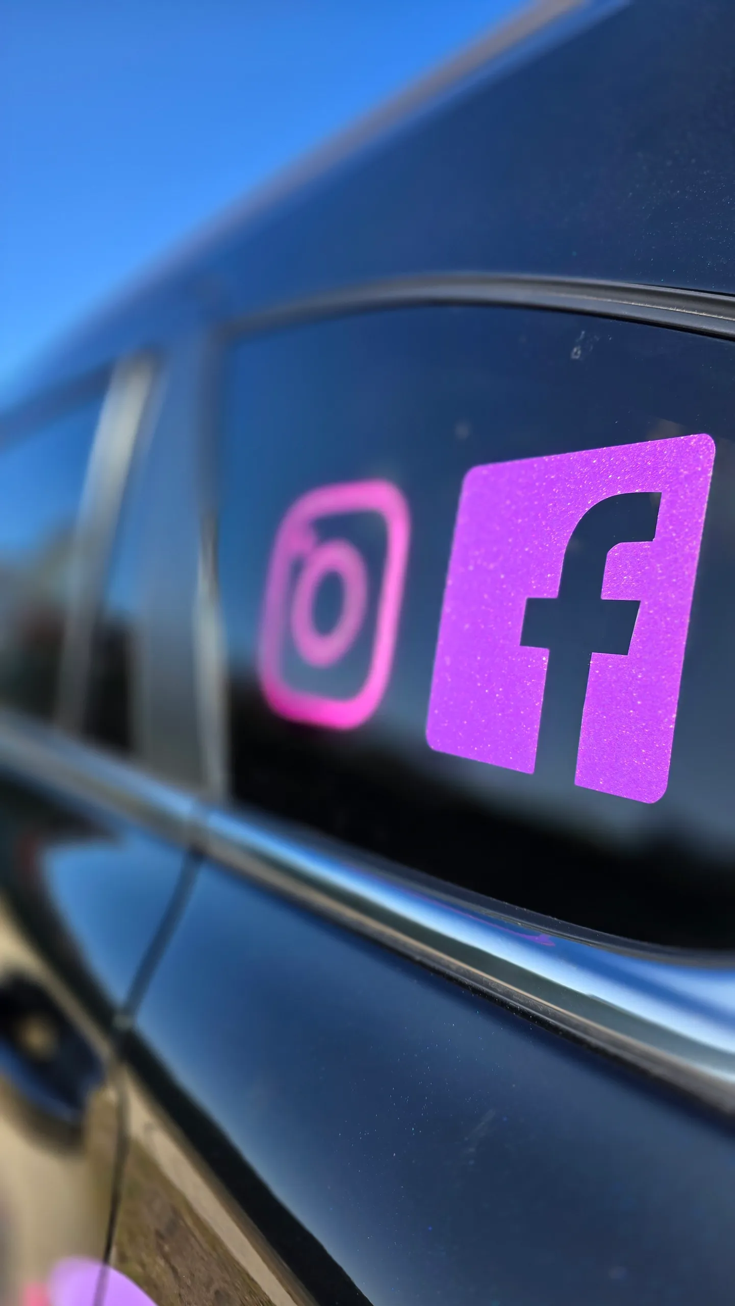 Pink and purple social-media icons on the rear side window of the For Finance Sake Isuzu MU-X