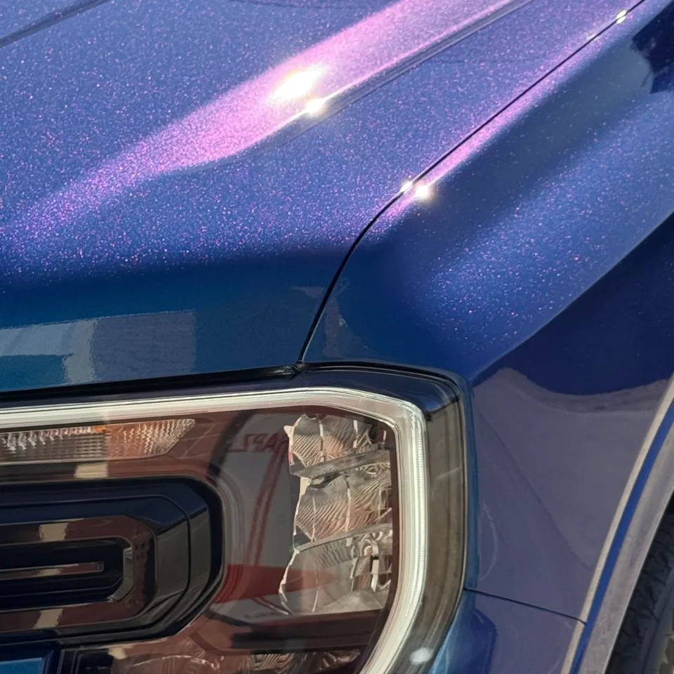 Blue and purple iridescent finish around the Ford Everest headlight and bonnet