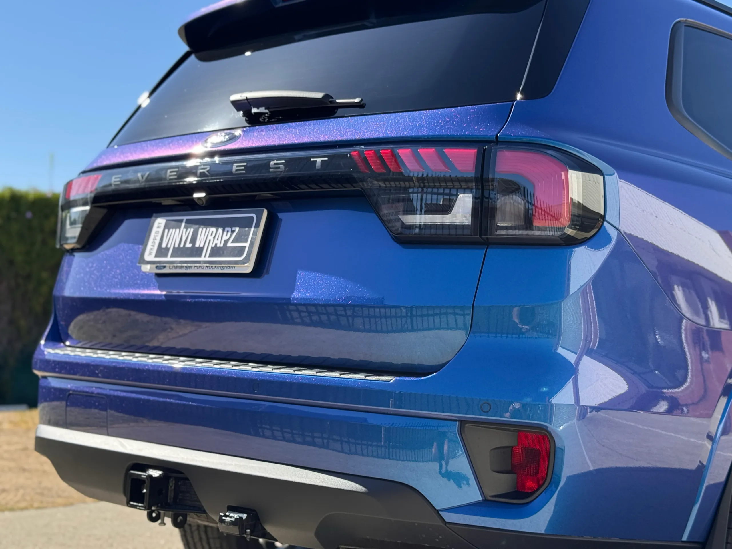 Low rear-quarter view of the iridescent blue Ford Everest tailgate and bumper