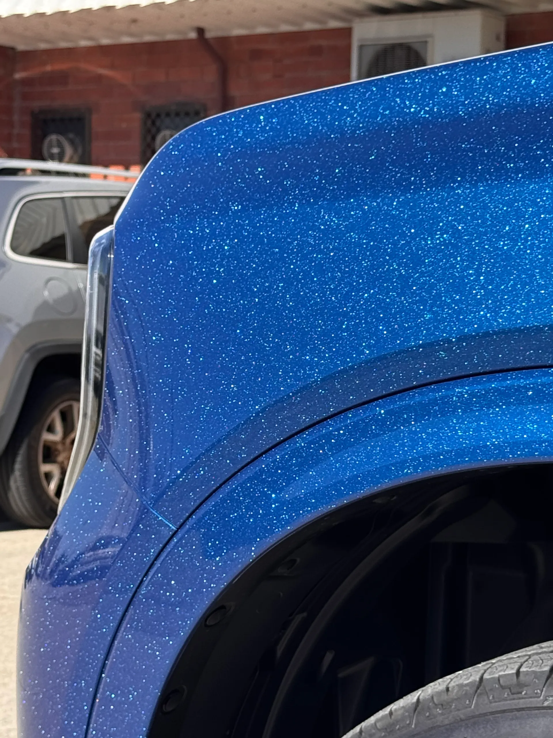 Close-up of the sparkling blue finish above the Ford Everest front wheel arch