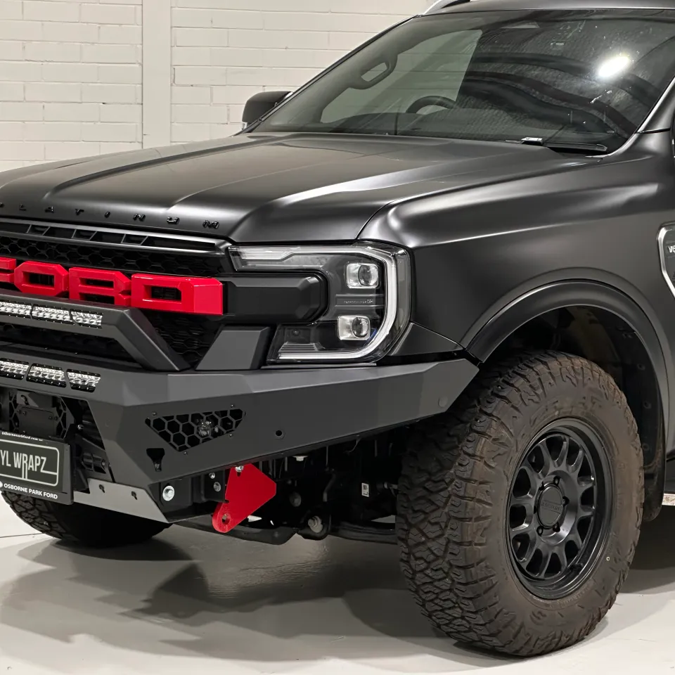 Satin black Ford Everest Platinum front corner with red Ford grille lettering and a black bullbar