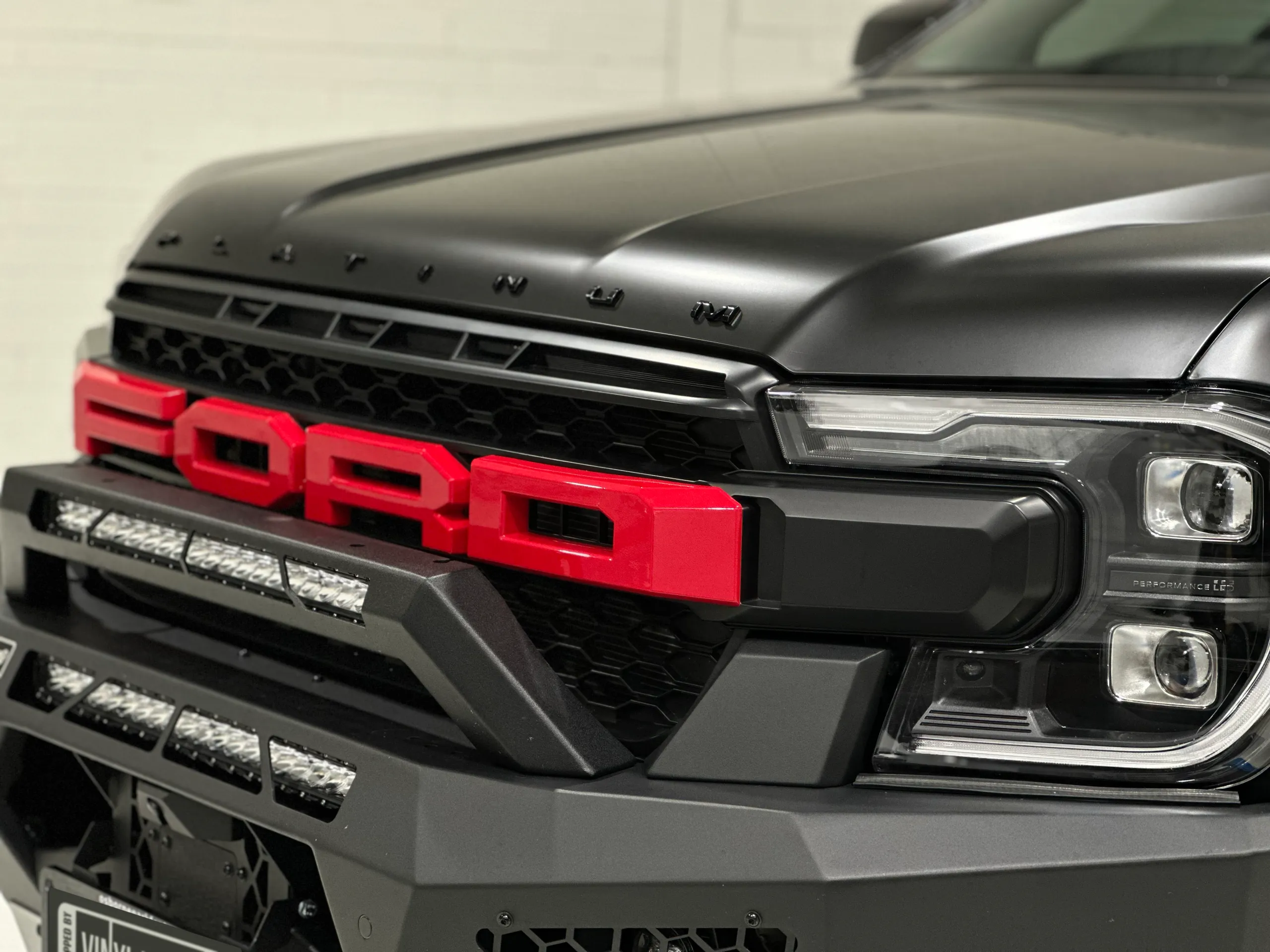 Red Ford grille lettering beneath the Everest Platinum satin black bonnet