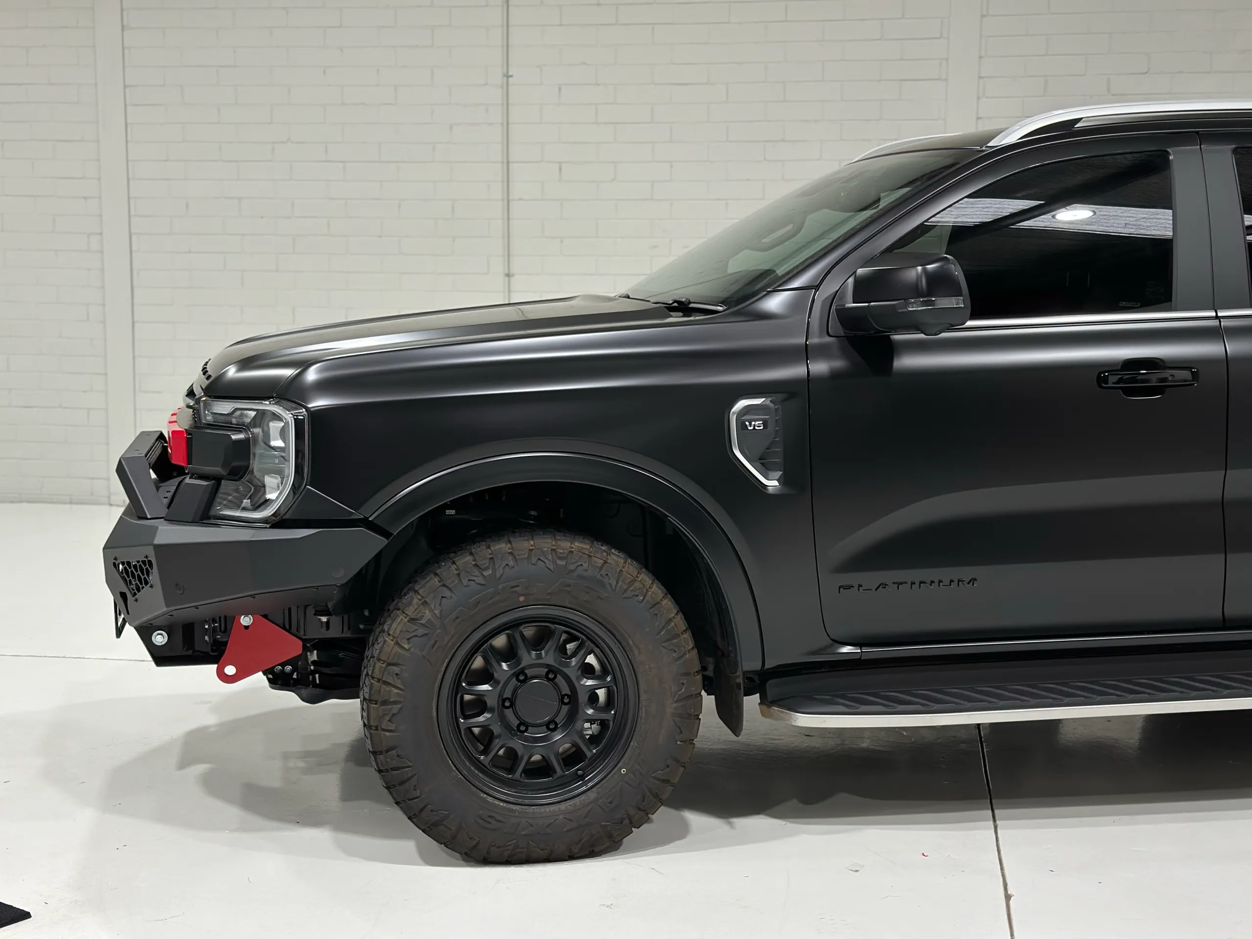 Satin black Ford Everest front guard, wheel and door inside the workshop