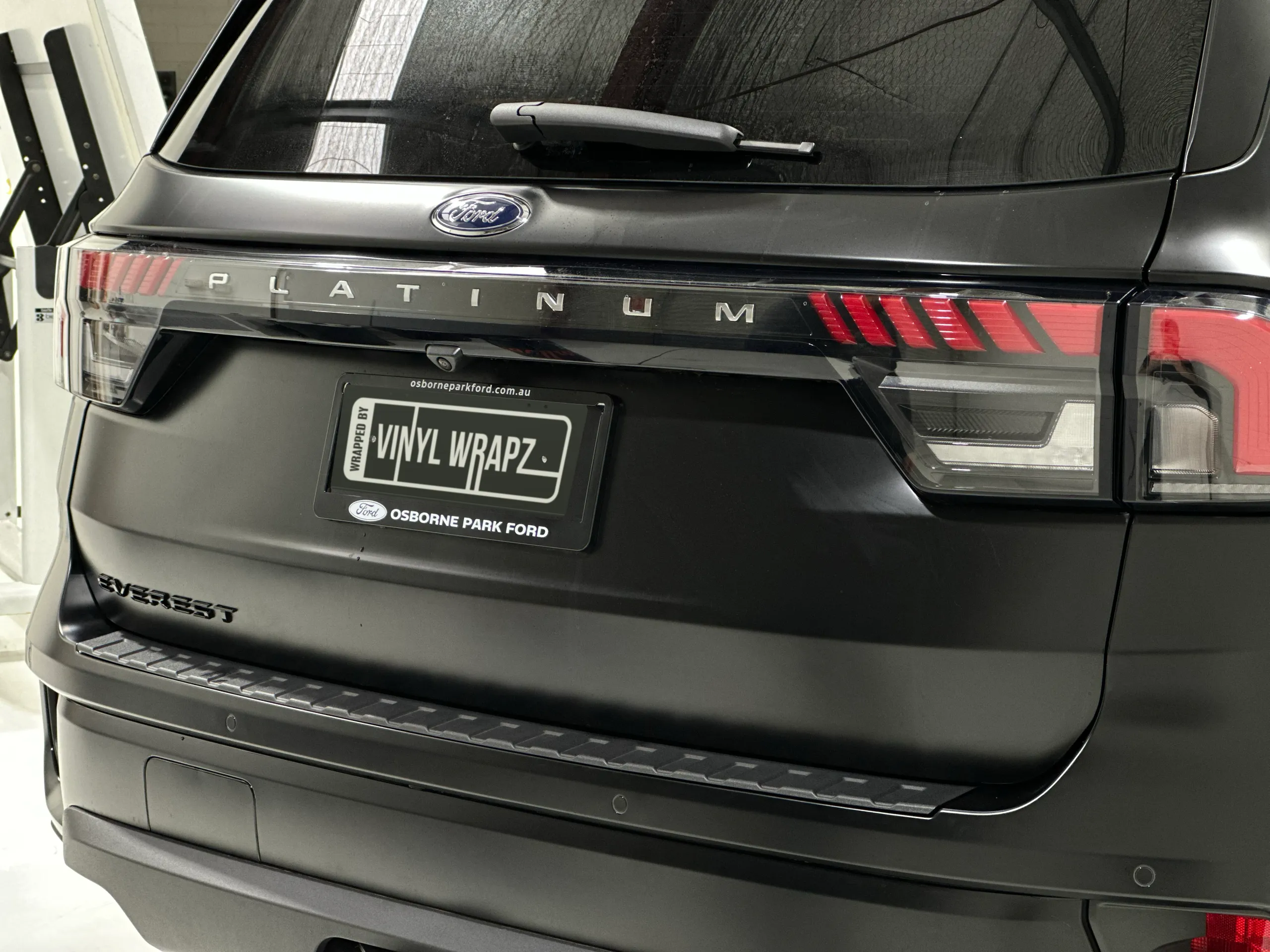 Satin black Everest tailgate with Ford and Platinum badges above the rear bumper