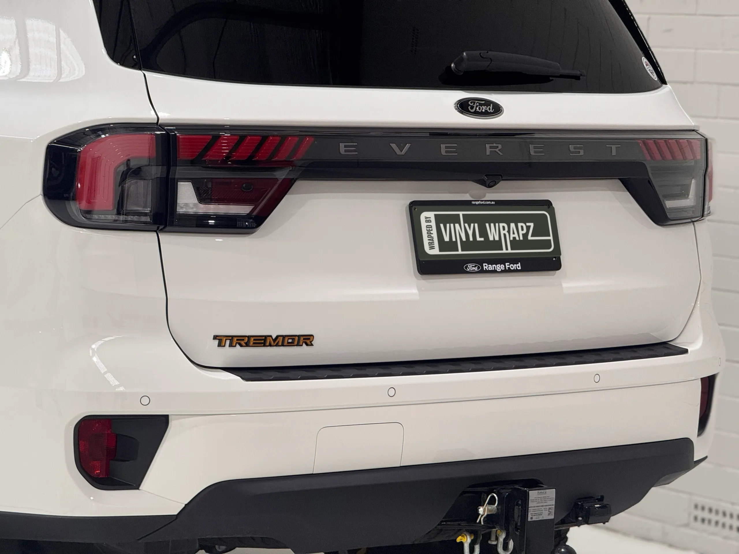 Close-up of the white Ford Everest tailgate, rear lights and Tremor badge