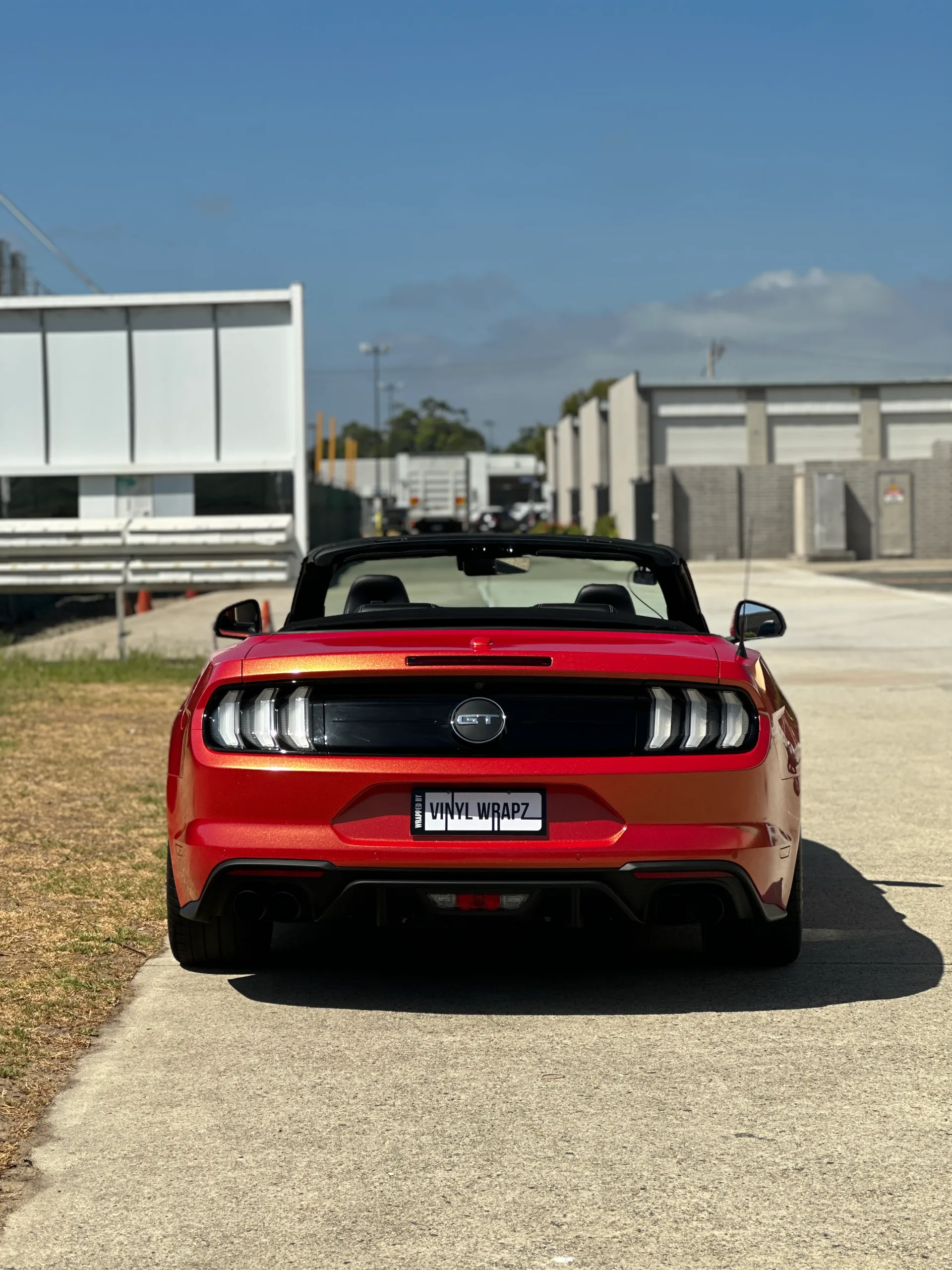 Red and gold colour-shift Ford Mustang convertible, rear