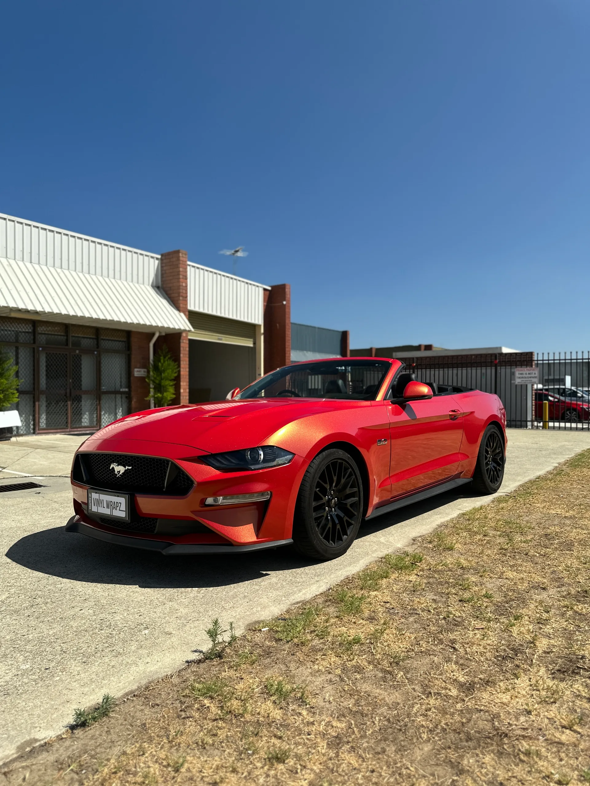 Red and gold colour-shift Ford Mustang convertible, front quarter