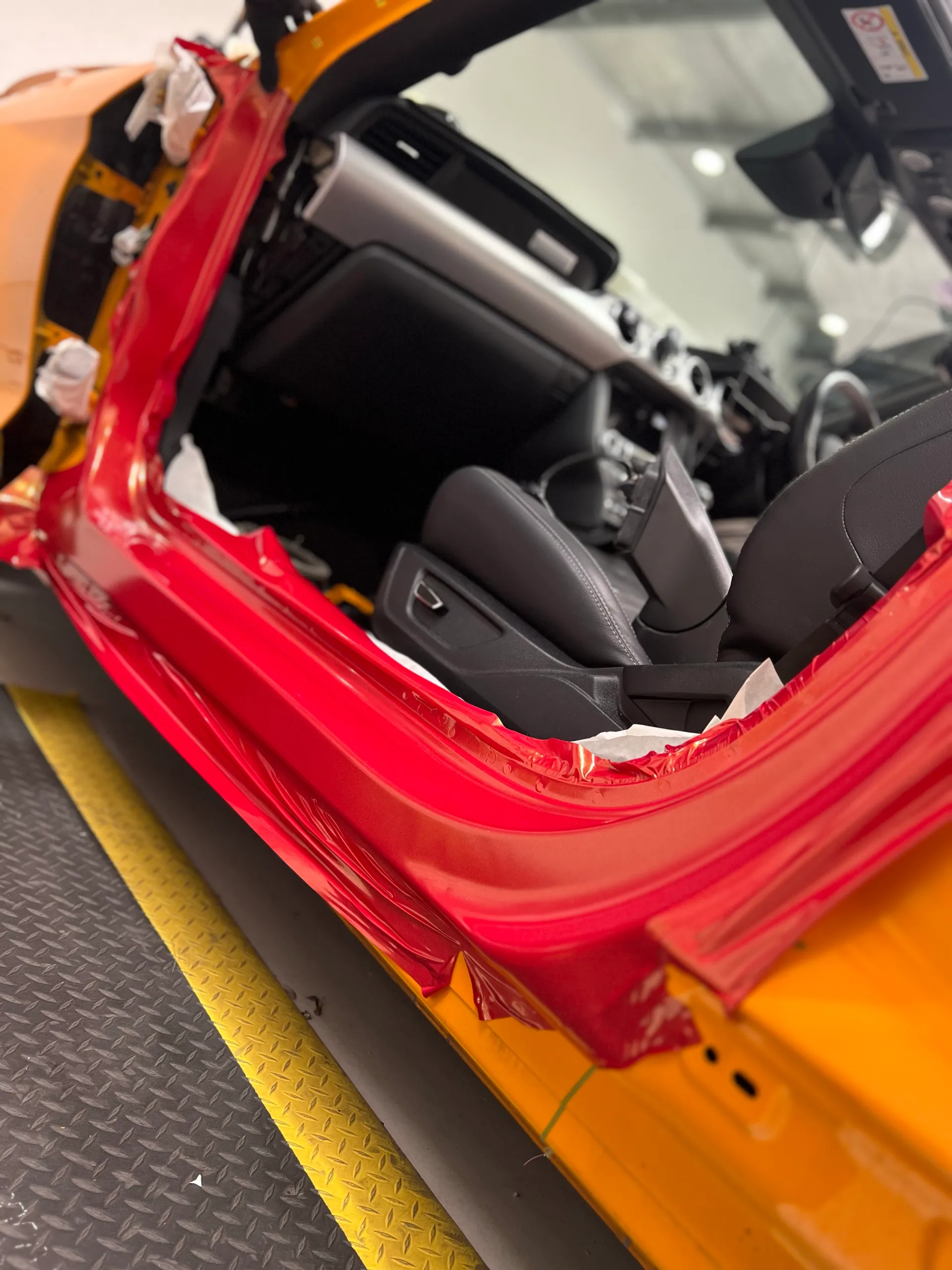 Red and gold colour-shift Ford Mustang convertible, door jamb detail