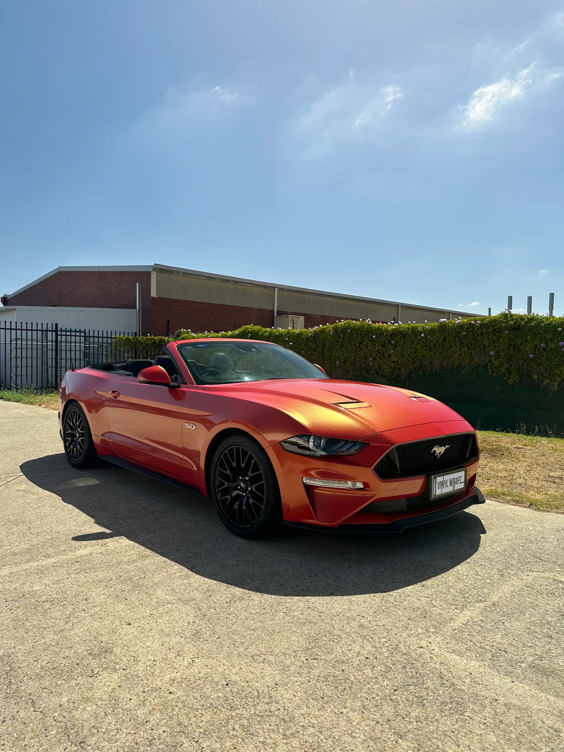 Red and gold colour-shift Ford Mustang convertible, front quarter