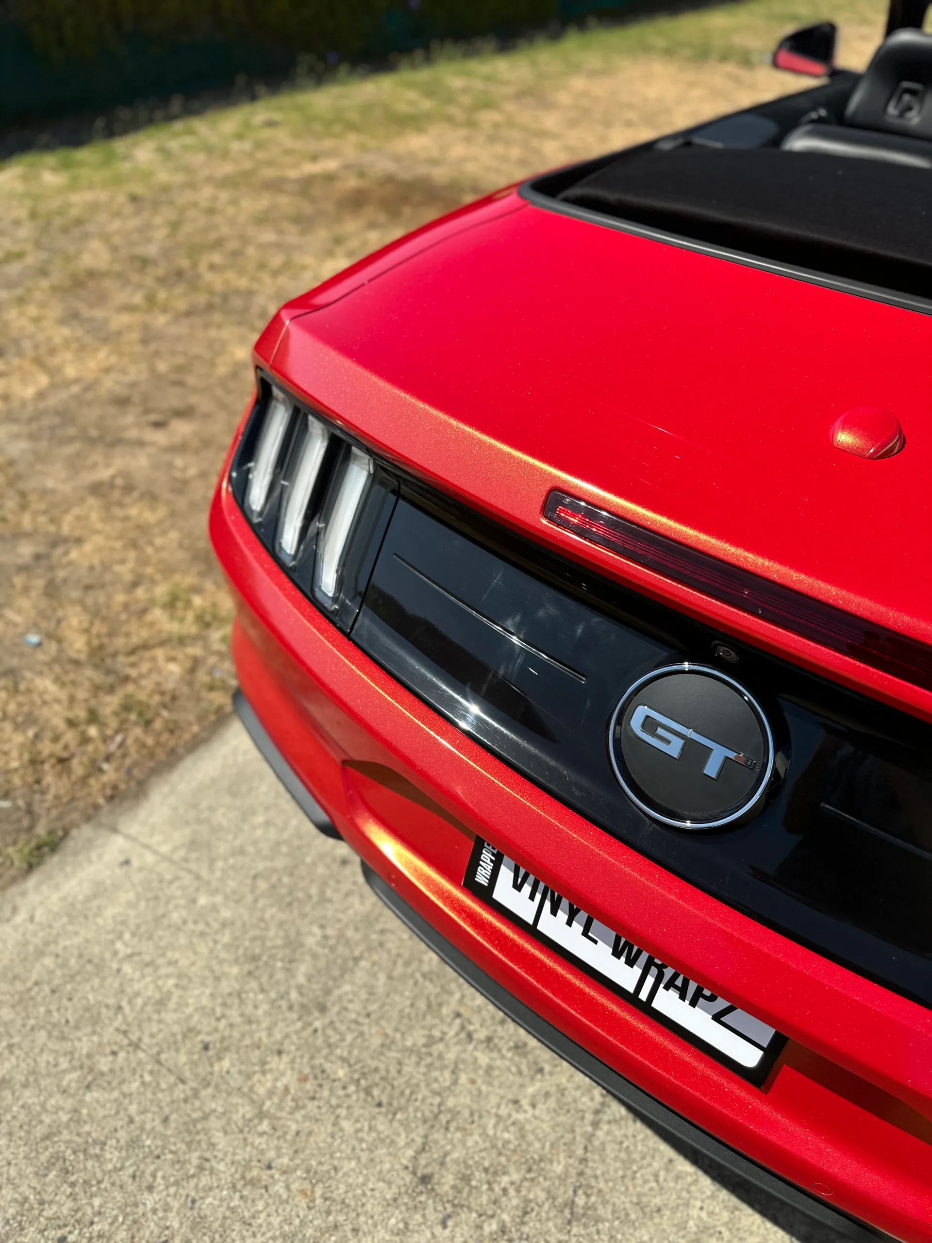 Red and gold colour-shift Ford Mustang convertible, rear detail