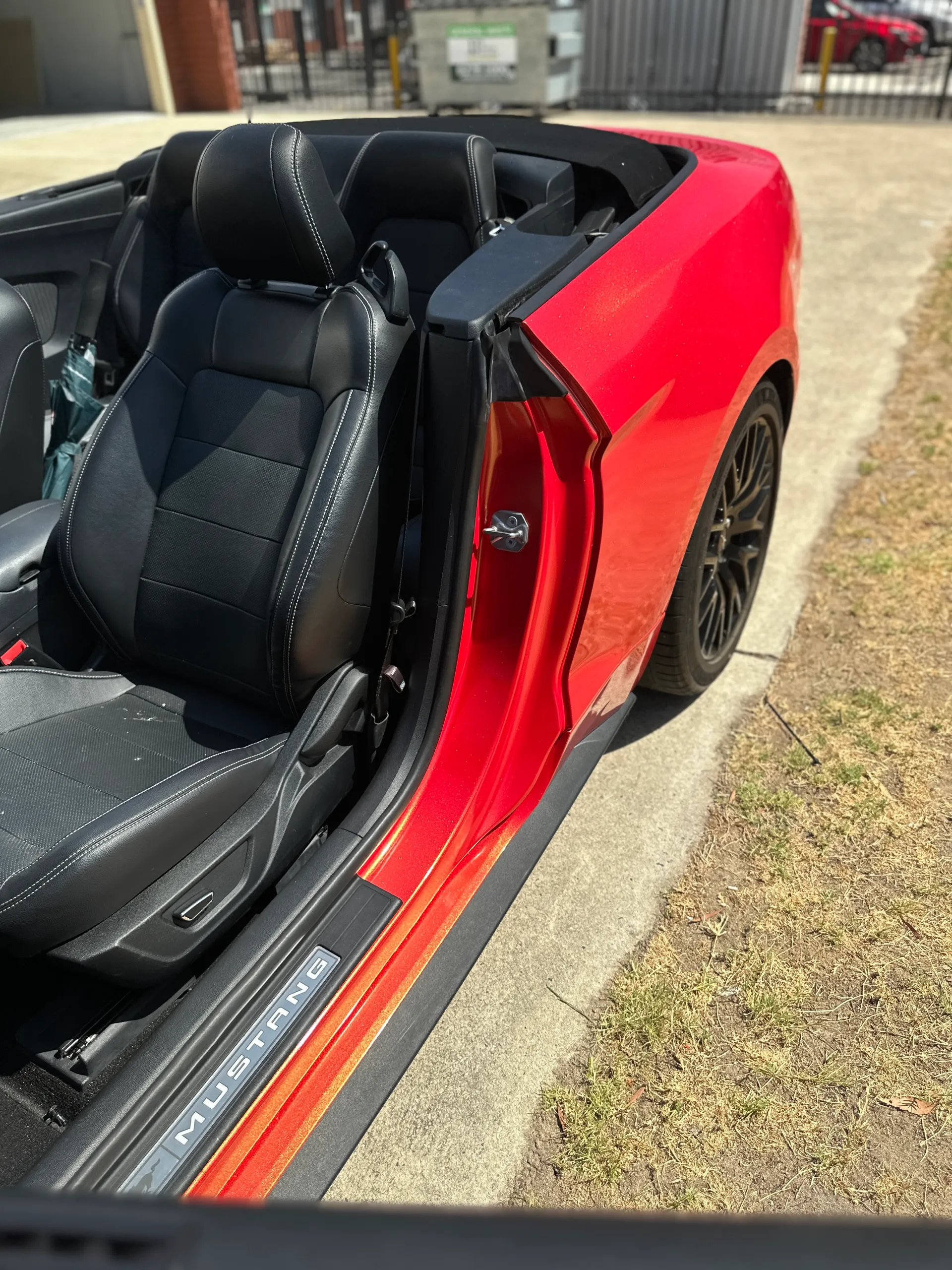Red and gold colour-shift Ford Mustang convertible, door jamb detail