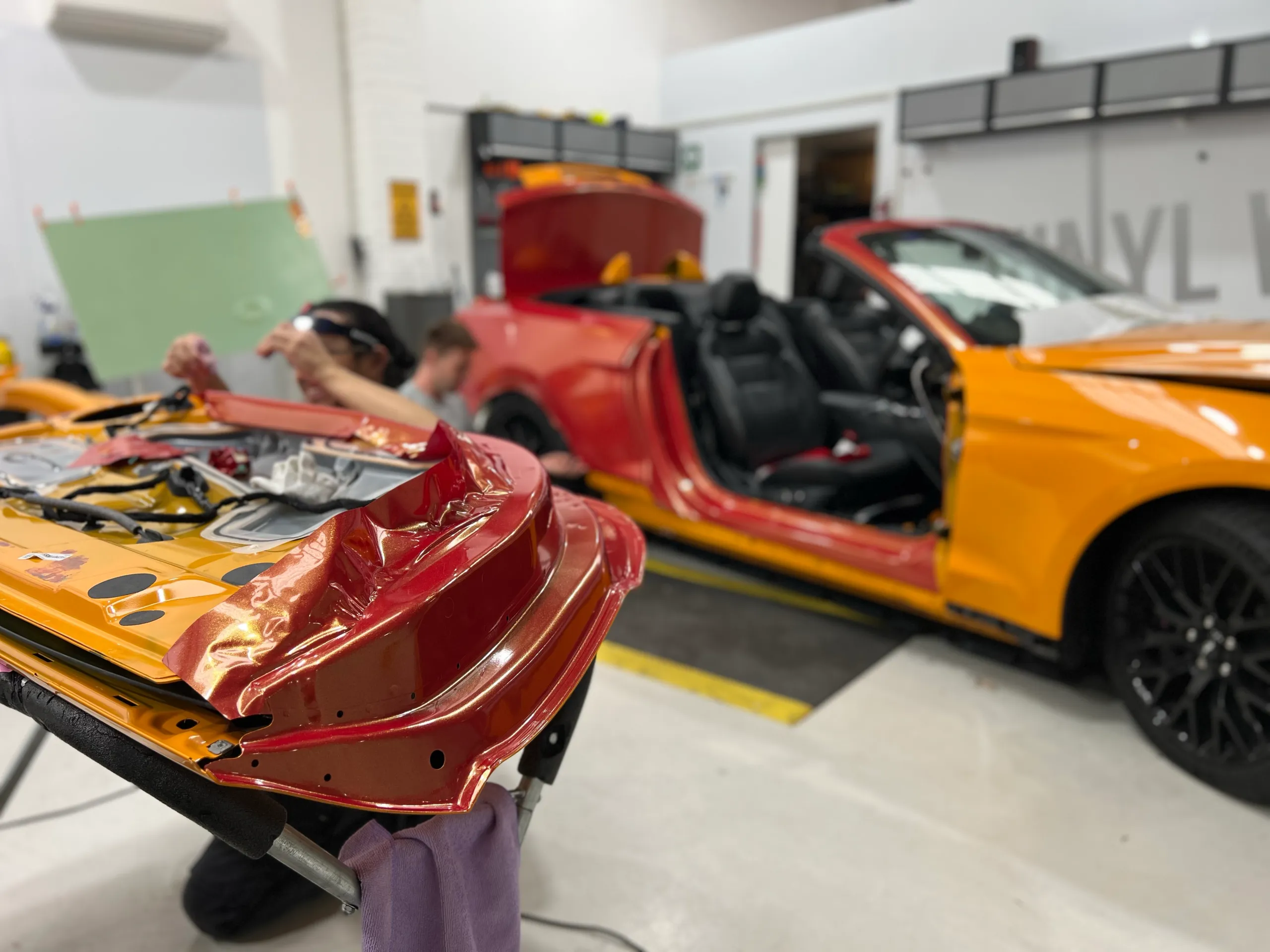 Red and gold colour-shift Ford Mustang convertible, installation detail
