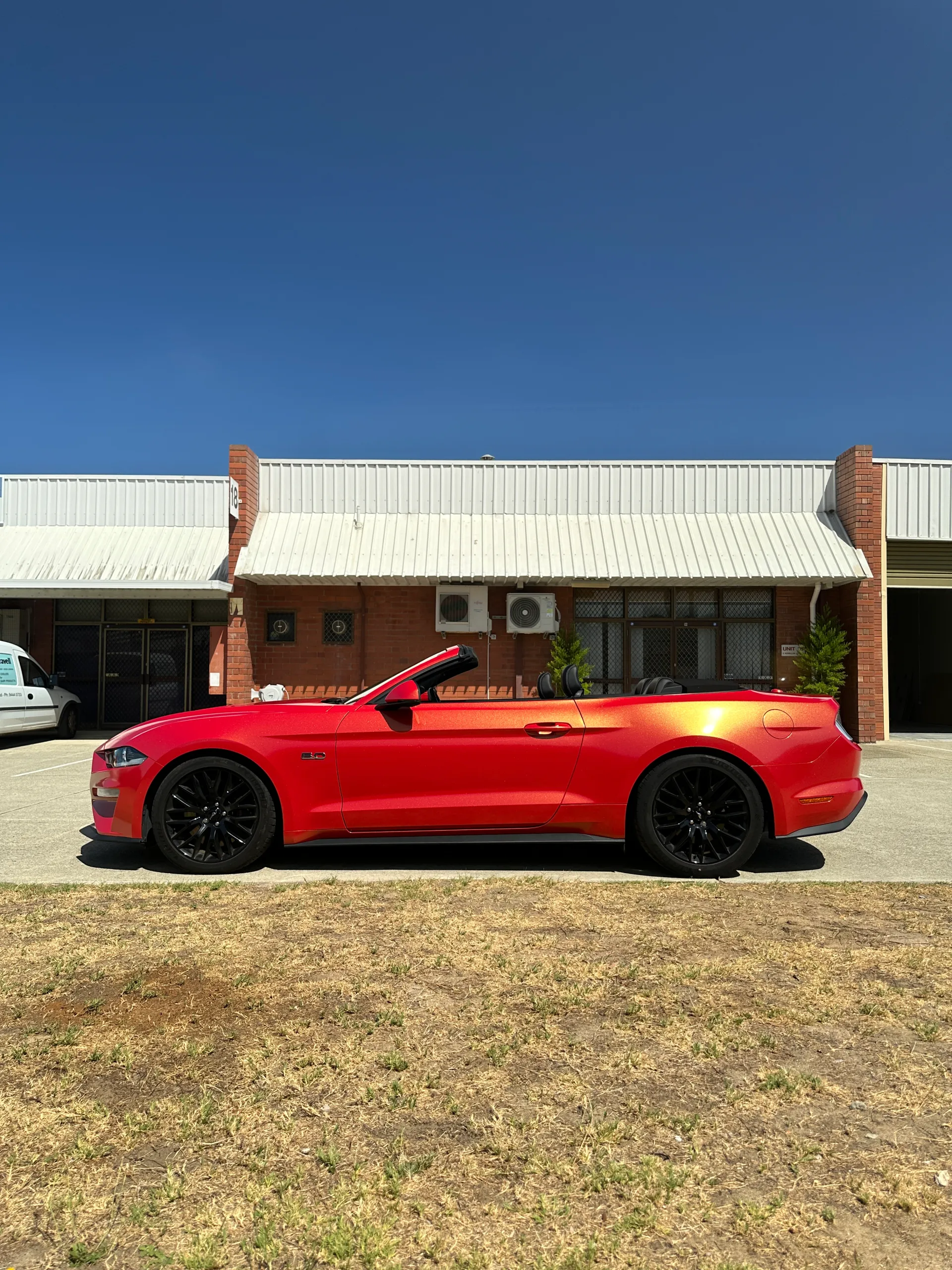 Red and gold colour-shift Ford Mustang convertible, side