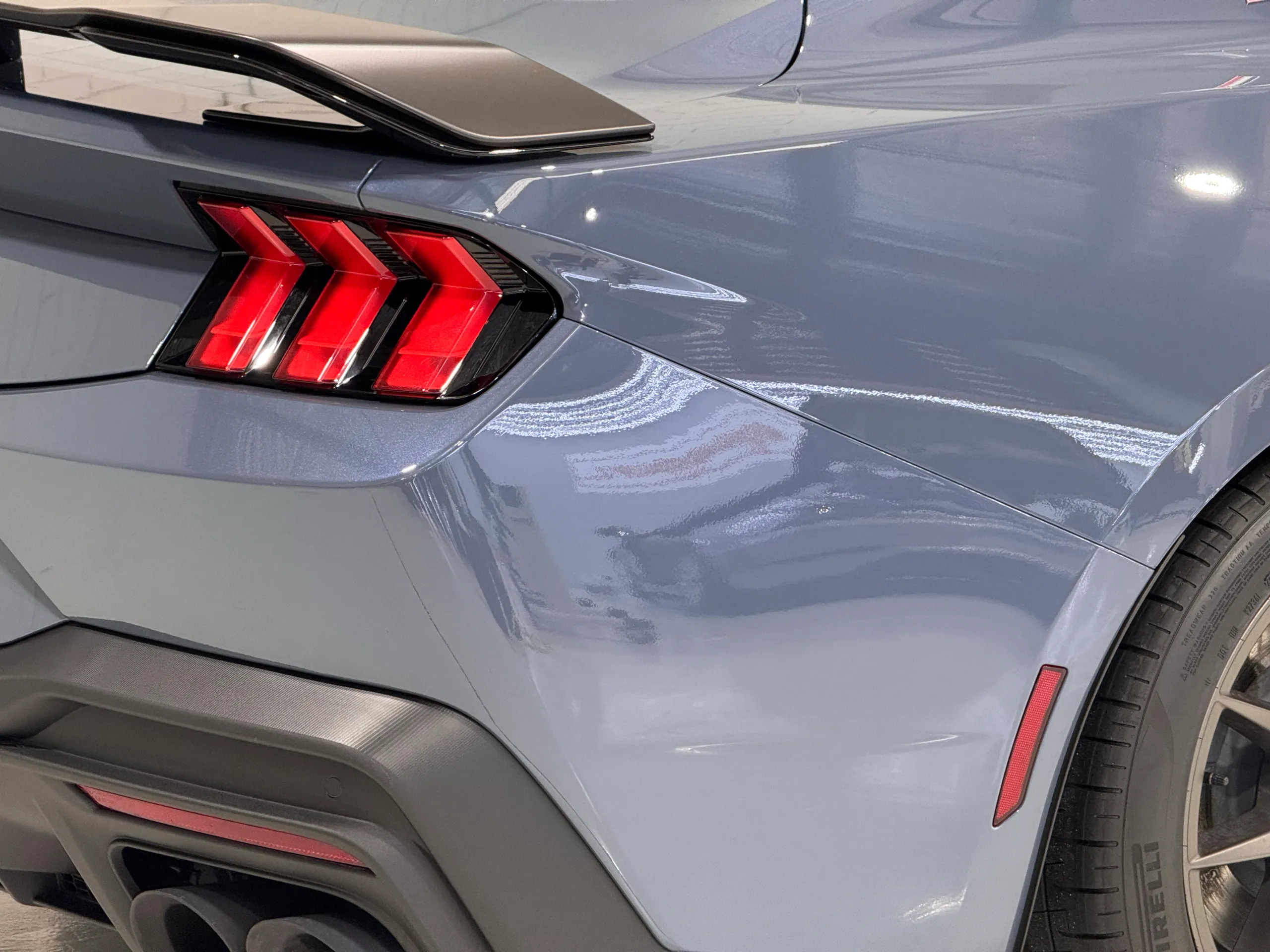 Ford Mustang Dark Horse rear light, blue-grey quarter panel and spoiler